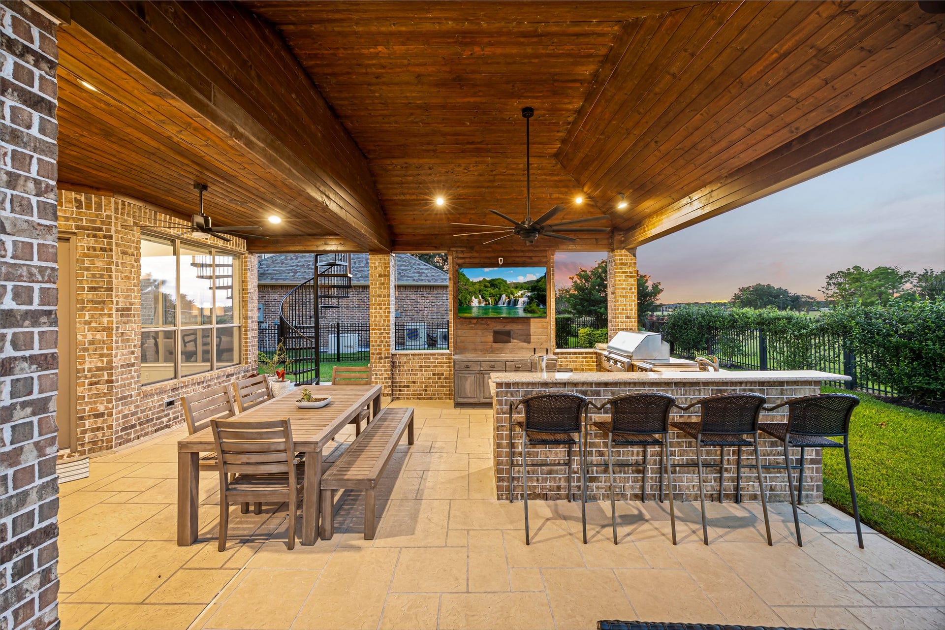 8642 Chickasaw Plum Way, Katy, TX 77494 Covered outdoor living area with bar seating, outdoor kitchen, and stained wood ceiling. Great sunsets from the backyard bar. Alfresco grill and flat grill, ice maker, and exterior surround sound.
