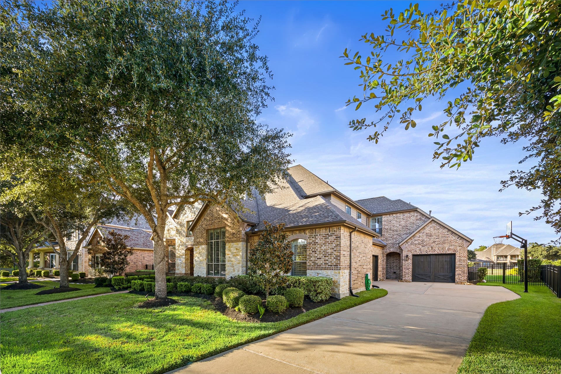 8642 Chickasaw Plum Way, Katy, TX 77494 Graceful exterior view showcasing the home's architecture, lush lawn, and extended driveway. New windows (2024).
