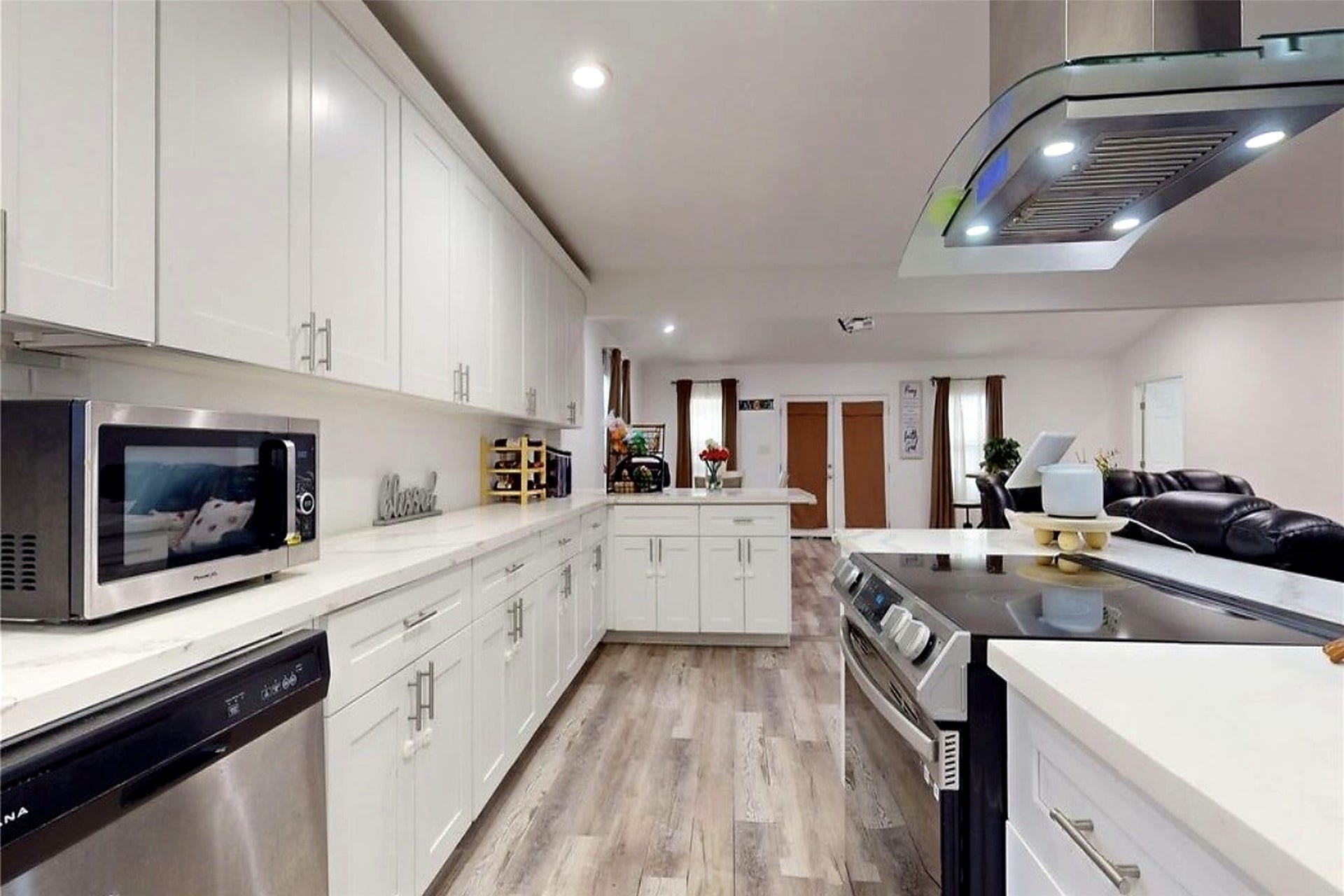 827 Dondell Street, Channelview, TX 77530 827 Dondell, Large kitchen with tall white cabinetry and great for storage, recessed lighting, modern hardware, stainless steel appliances (electric range) and quartz countertops