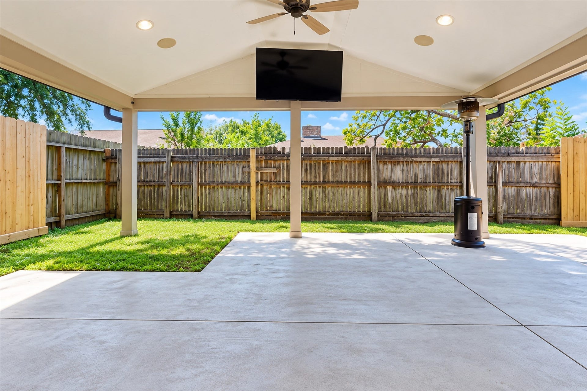 827 Dondell Street, Channelview, TX 77530 827 Dondell, Covered concrete outdoor patio with vaulted cielings recessed lighting, ceiling fan, and mounted TV. Fenced backyard for privacy.
