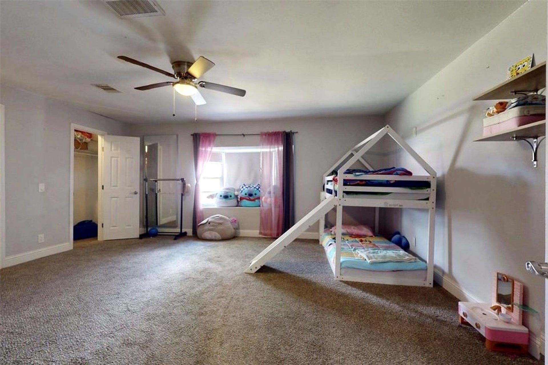 827 Dondell Street, Channelview, TX 77530 827 Dondell, Large currently used as a bedroom, can be used as a game room or office, large walk through closet and a bay window with tan carpet.