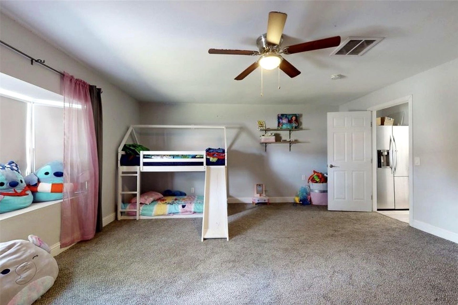 827 Dondell Street, Channelview, TX 77530 827 Dondell, Large currently used as a bedroom, can be used as a game room or office, large walk through closet a bay window with tan carpet and ceiling fan and it faced the front yard.