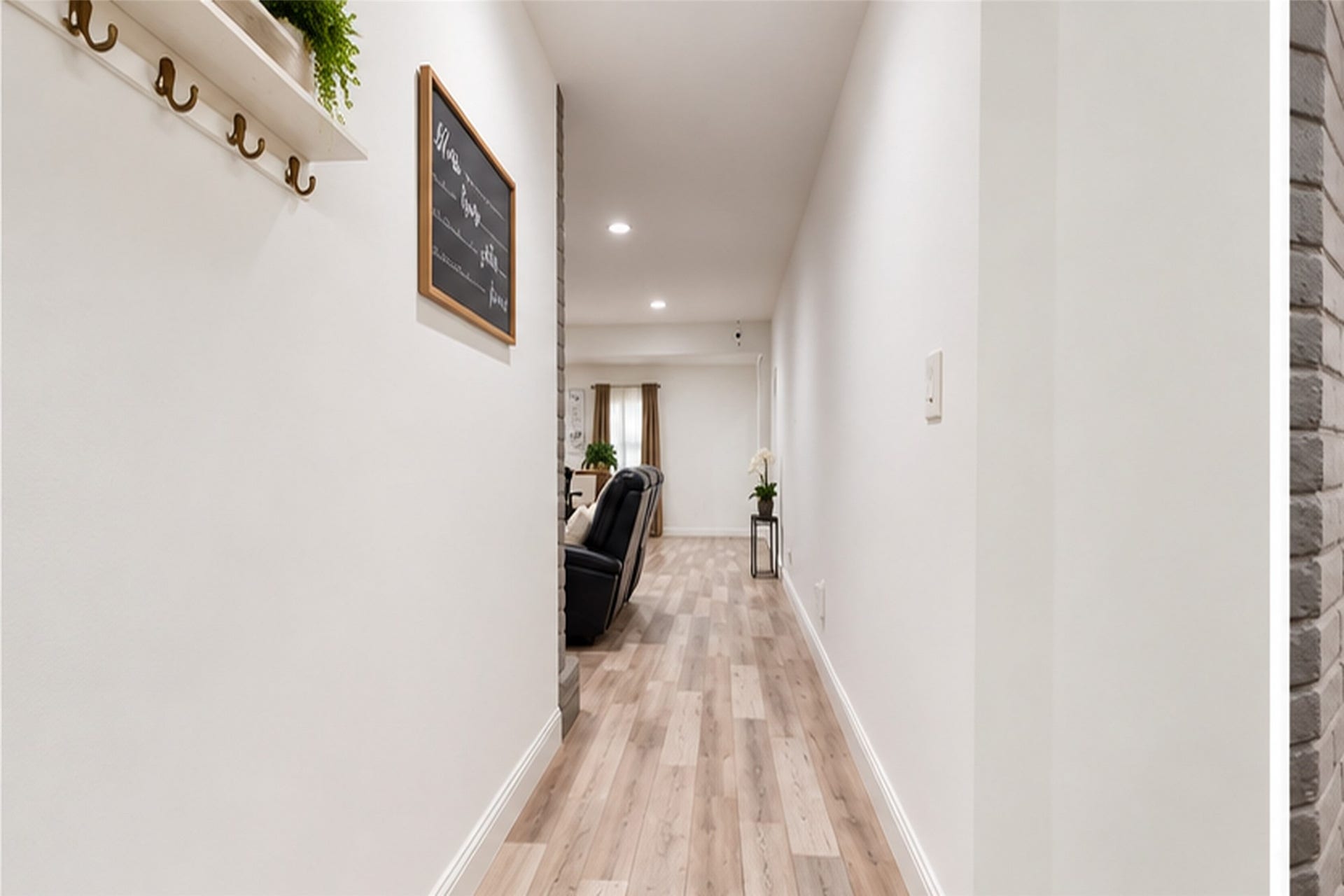 827 Dondell Street, Channelview, TX 77530 827 Dondell, Hallway entry to home with wooden grayish laminate throughout the entire house, with white walls.