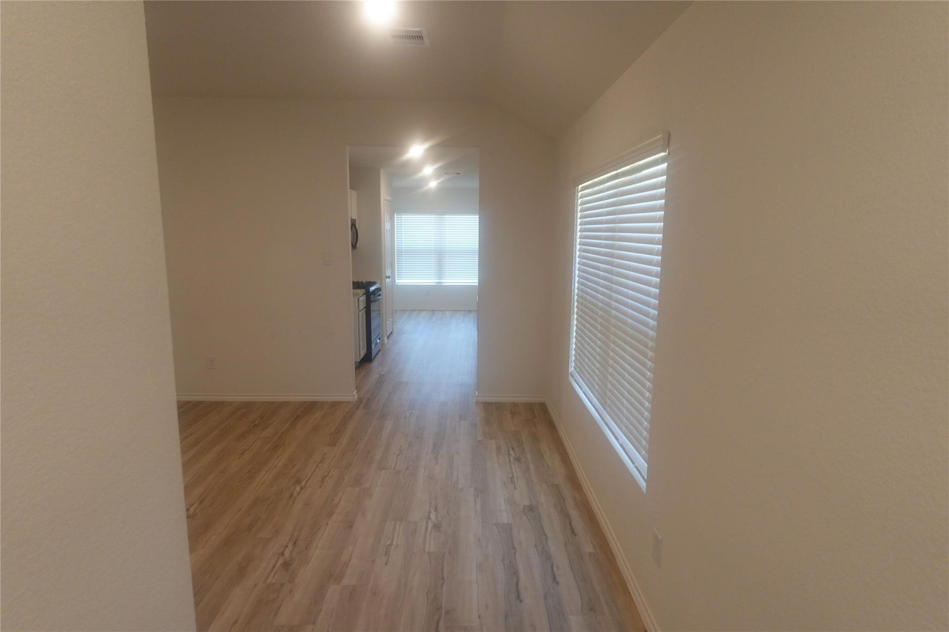Spacious living area with plank flooring