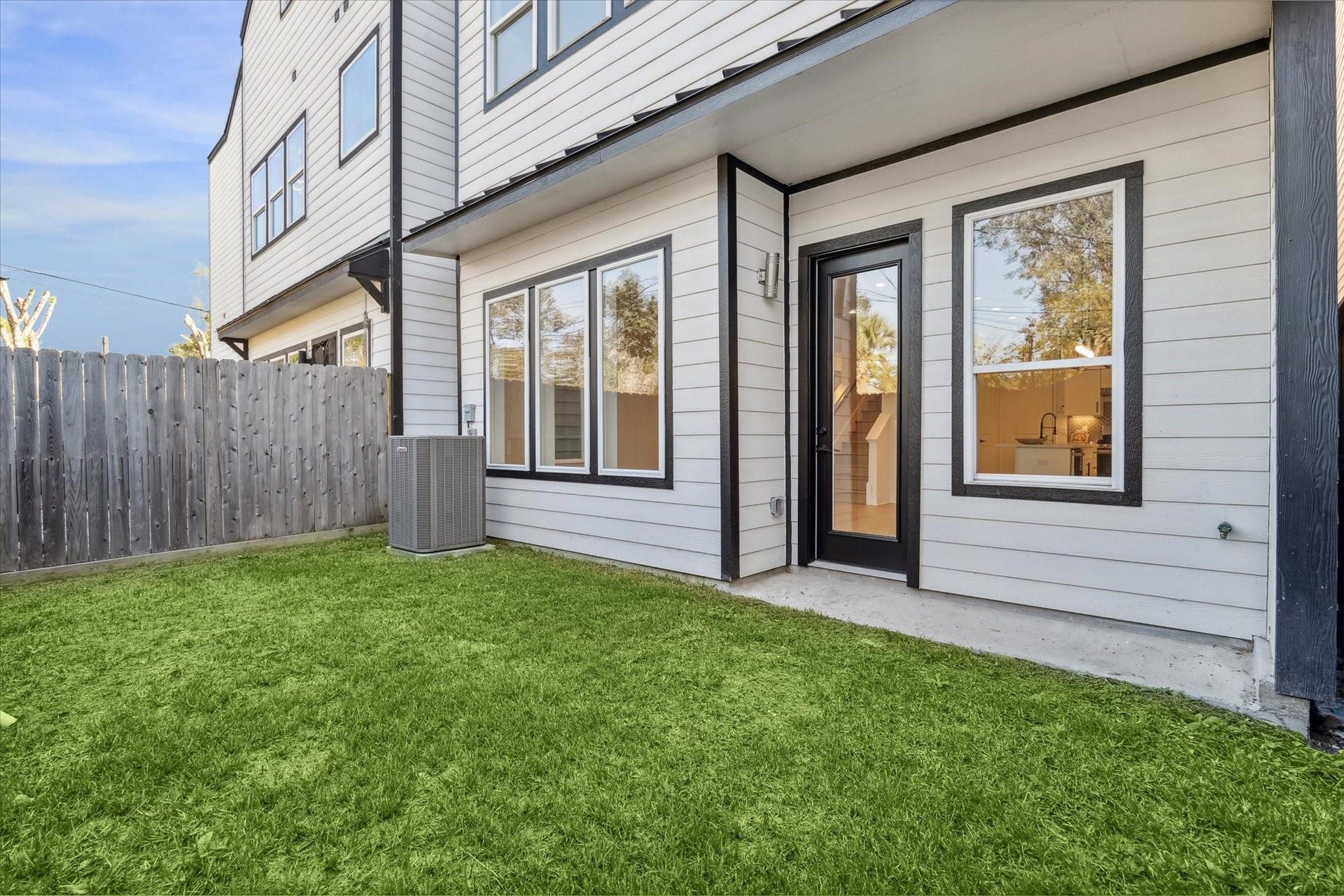 Spacious backyard with lush greenery and a low-maintenance setup, perfect for relaxing or entertaining.
