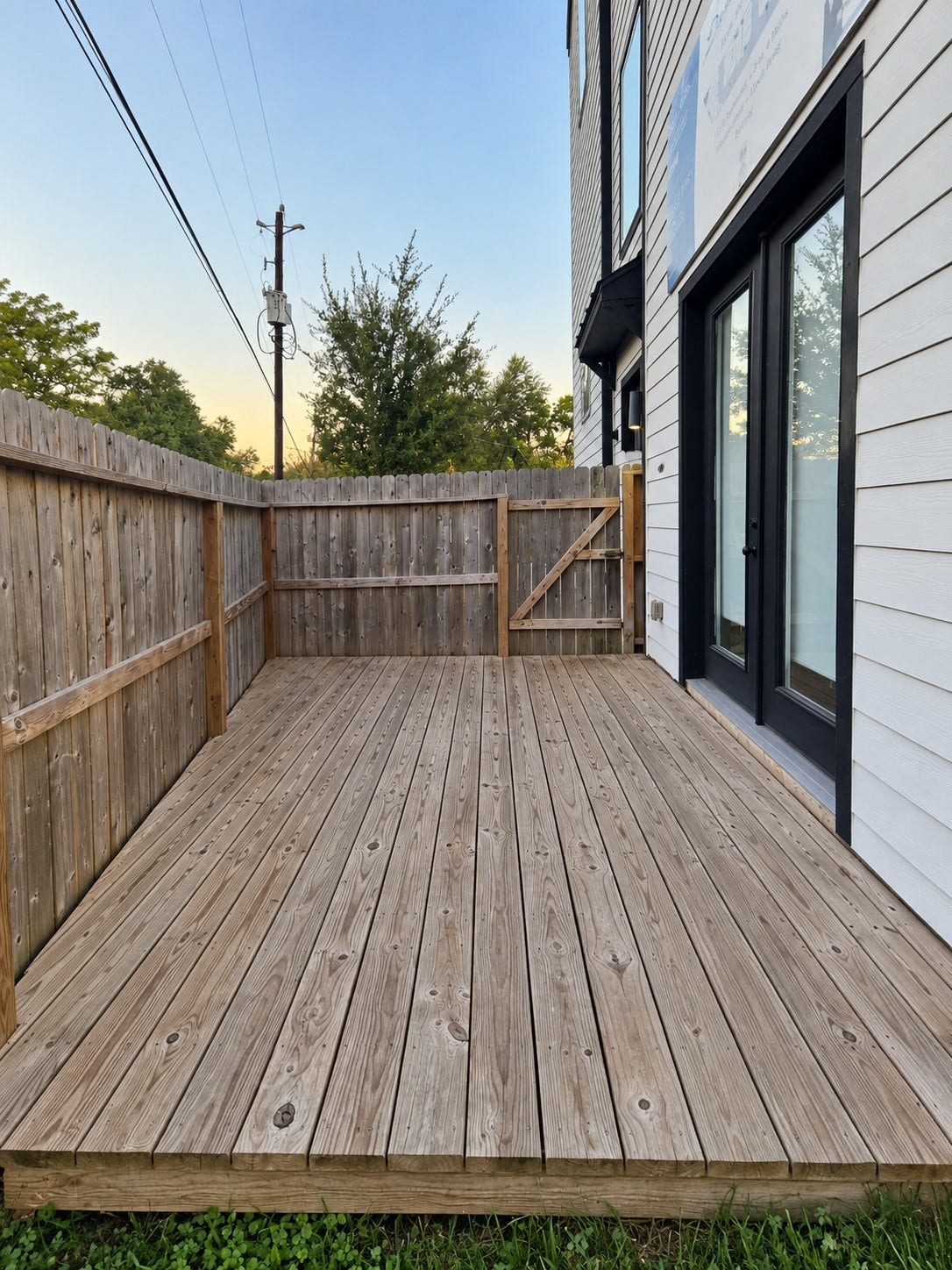Decked side yard followed by a spacious lush backyard