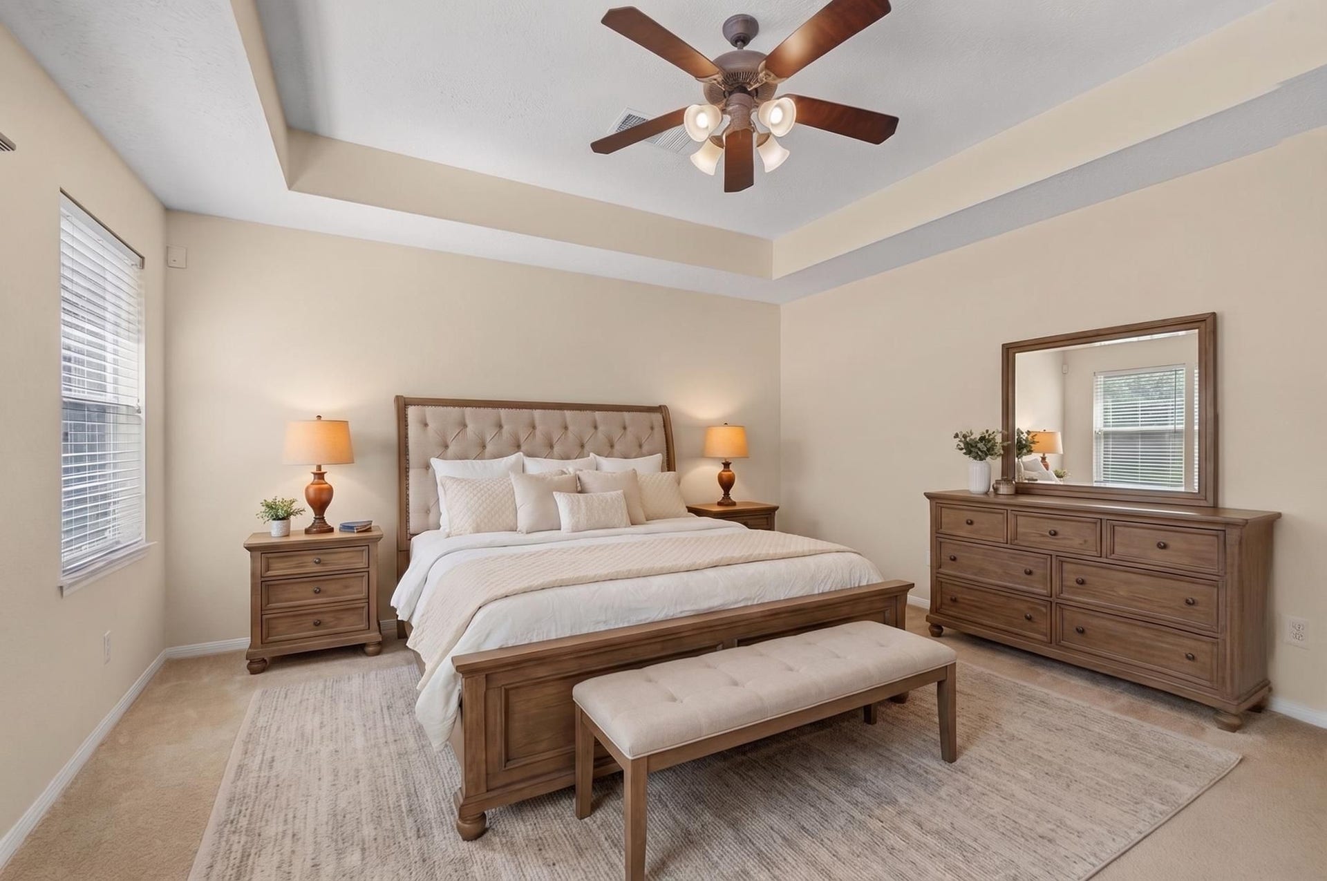 Primary suite located on the first floor with an en-suite bathroom, high ceilings, and beautiful view of the pool (Virtually staged).
