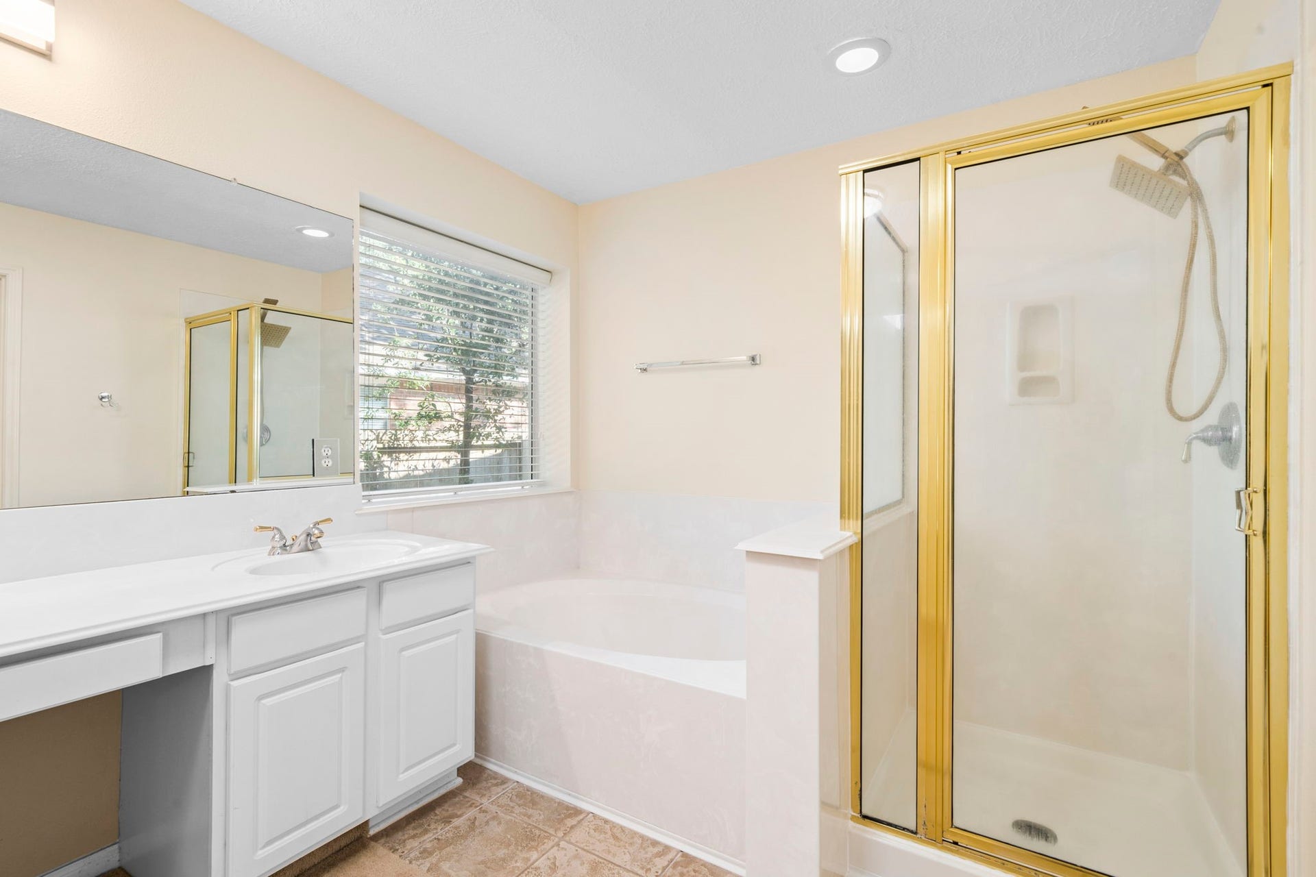 En-suite primary bathroom with double sinks, soaking tub, walk in shower, and a massive primary closet!