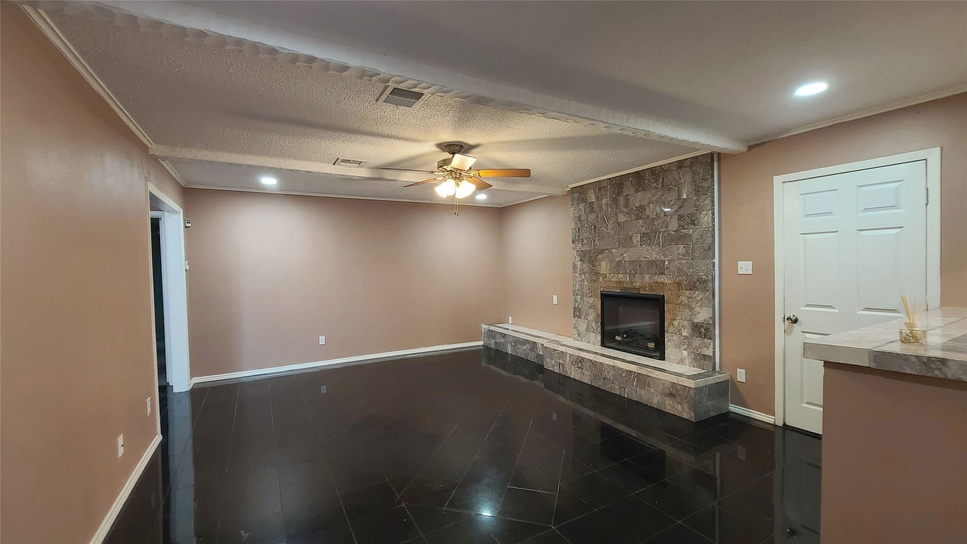 902 Ashford Parkway, Houston, TX 77077 The family room boasts a beautiful tile fireplace, creating a warm and inviting focal point for gatherings.