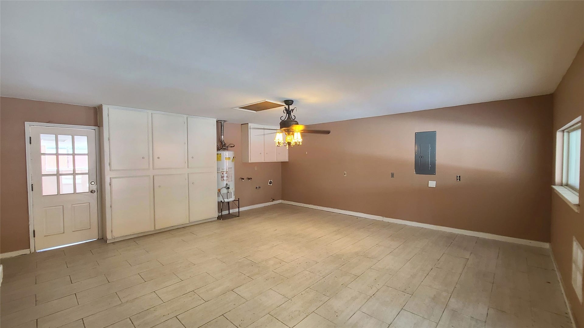 902 Ashford Parkway, Houston, TX 77077 Spacious room with ample built-in cabinetry, a ceiling fan, and natural light, perfect for versatile use.