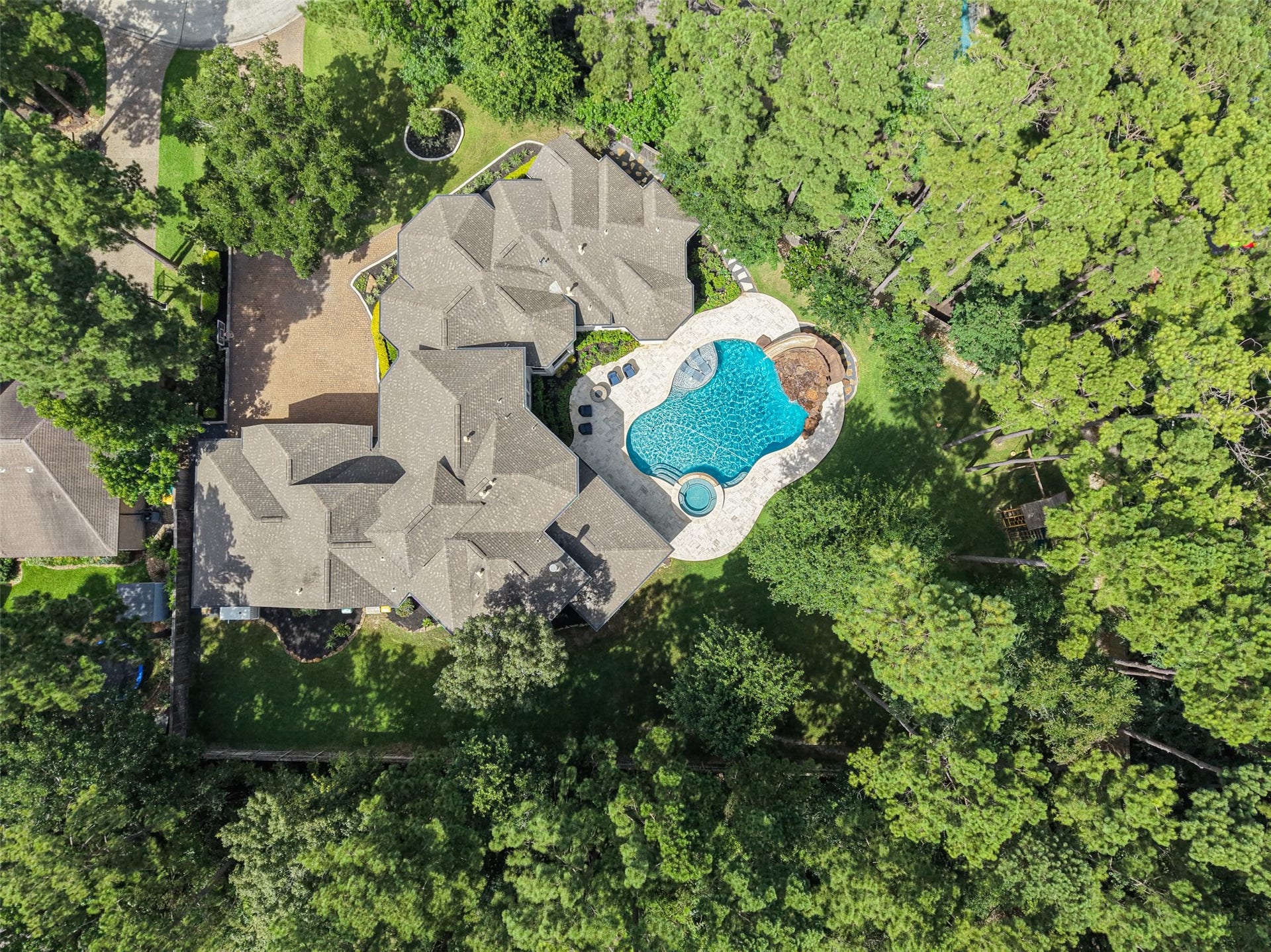 19 Harmony Links Place, The Woodlands, TX 77382 Nestled on an expansive lot with extensive lush landscaping situated on over HALF an ACRE in the highly sought-after Village of Sterling Ridge!
