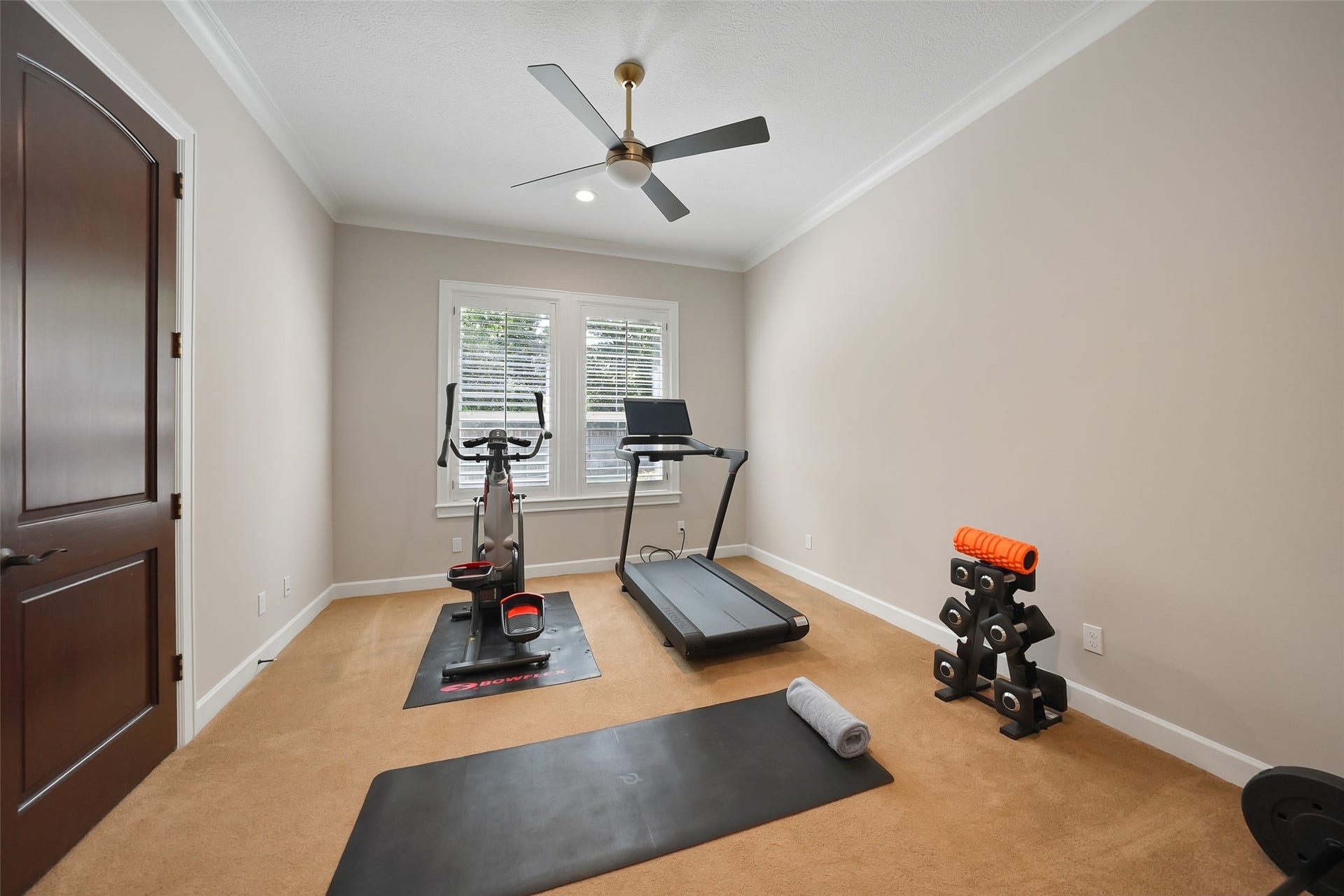 19 Harmony Links Place, The Woodlands, TX 77382 This secondary bedroom suite is located on the main level! It is presently utilized as a gym and features large windows with plantation shutters!