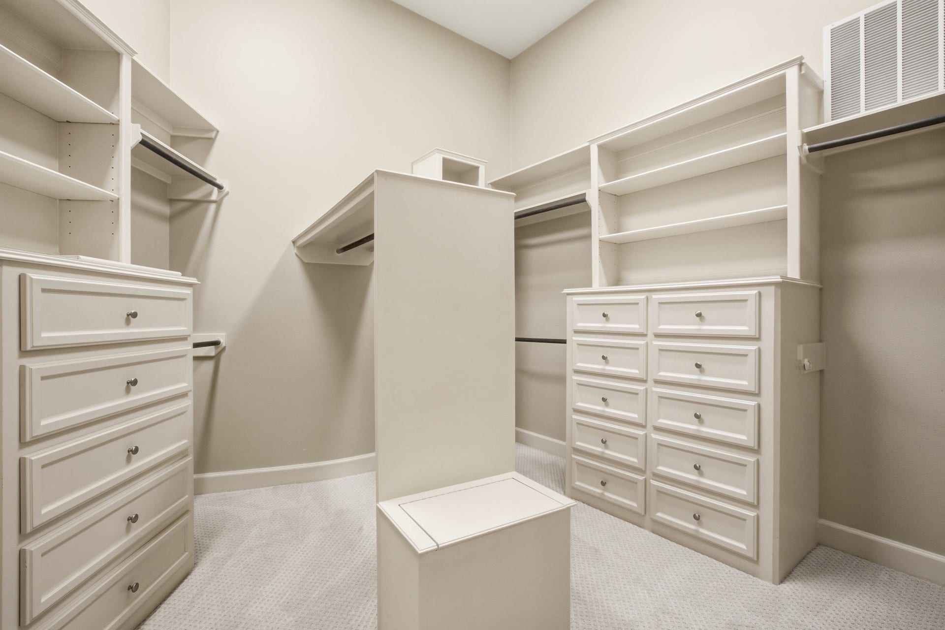 3518 River Forest Drive, Richmond, TX 77406 Discover the elegance and functionality of this expansive primary closet, featuring ample shelving, multiple drawers, and versatile hanging space for all your wardrobe essentials.
