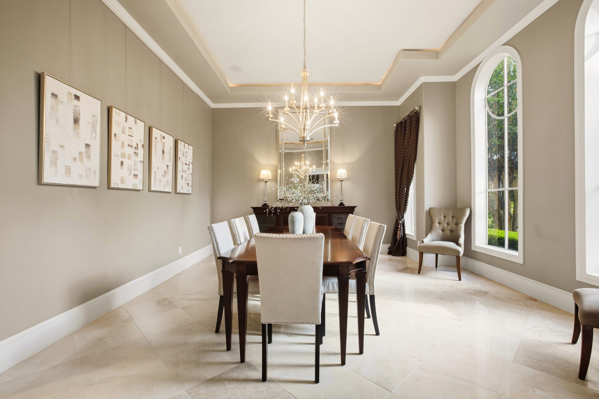 3518 River Forest Drive, Richmond, TX 77406 Elegant dining room with high ceilings, featuring a sophisticated chandelier, large windows, and a spacious table perfect for gatherings.