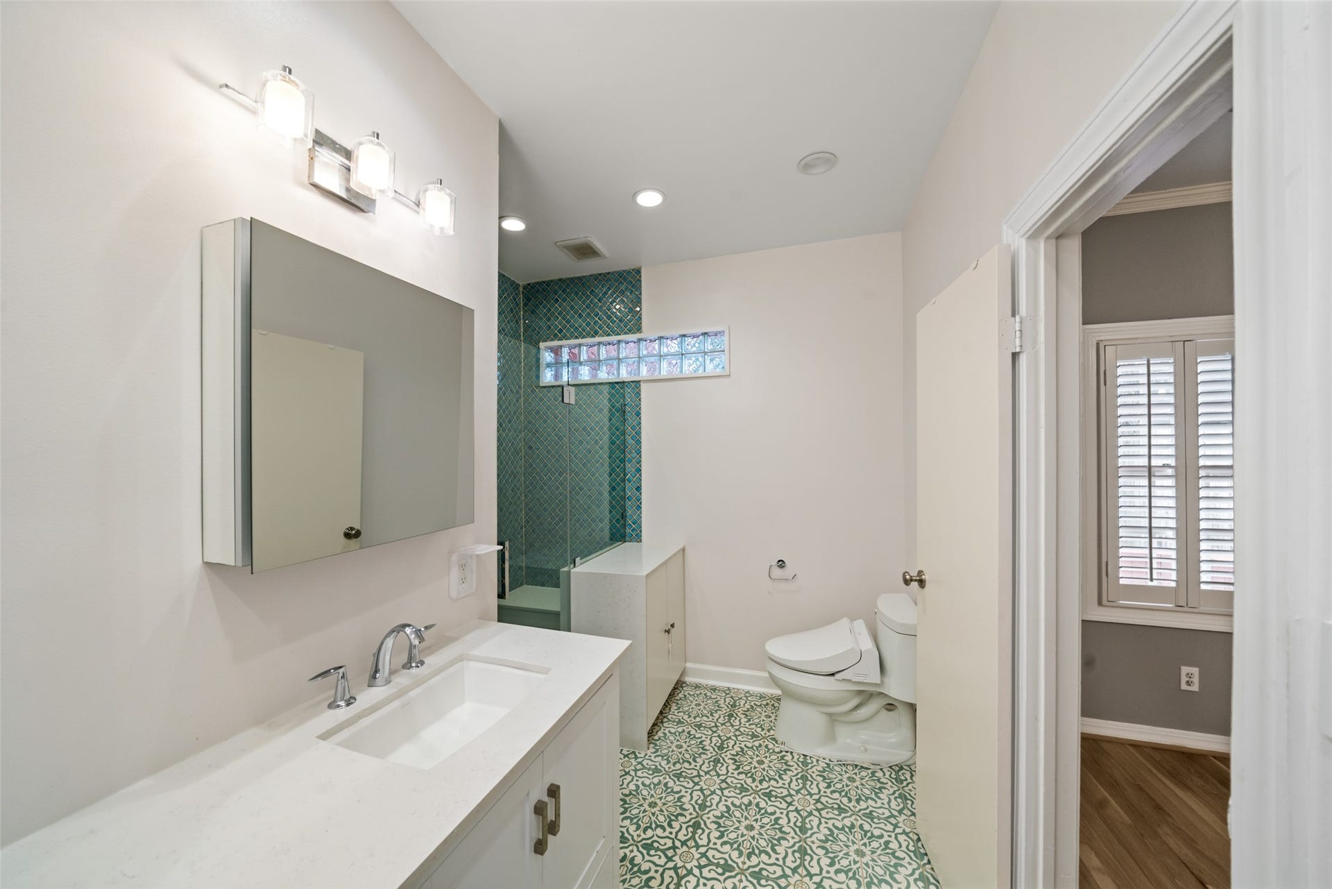 Anther view of the primary en-suite bath, featuring a glass-enclosed walk-in shower.