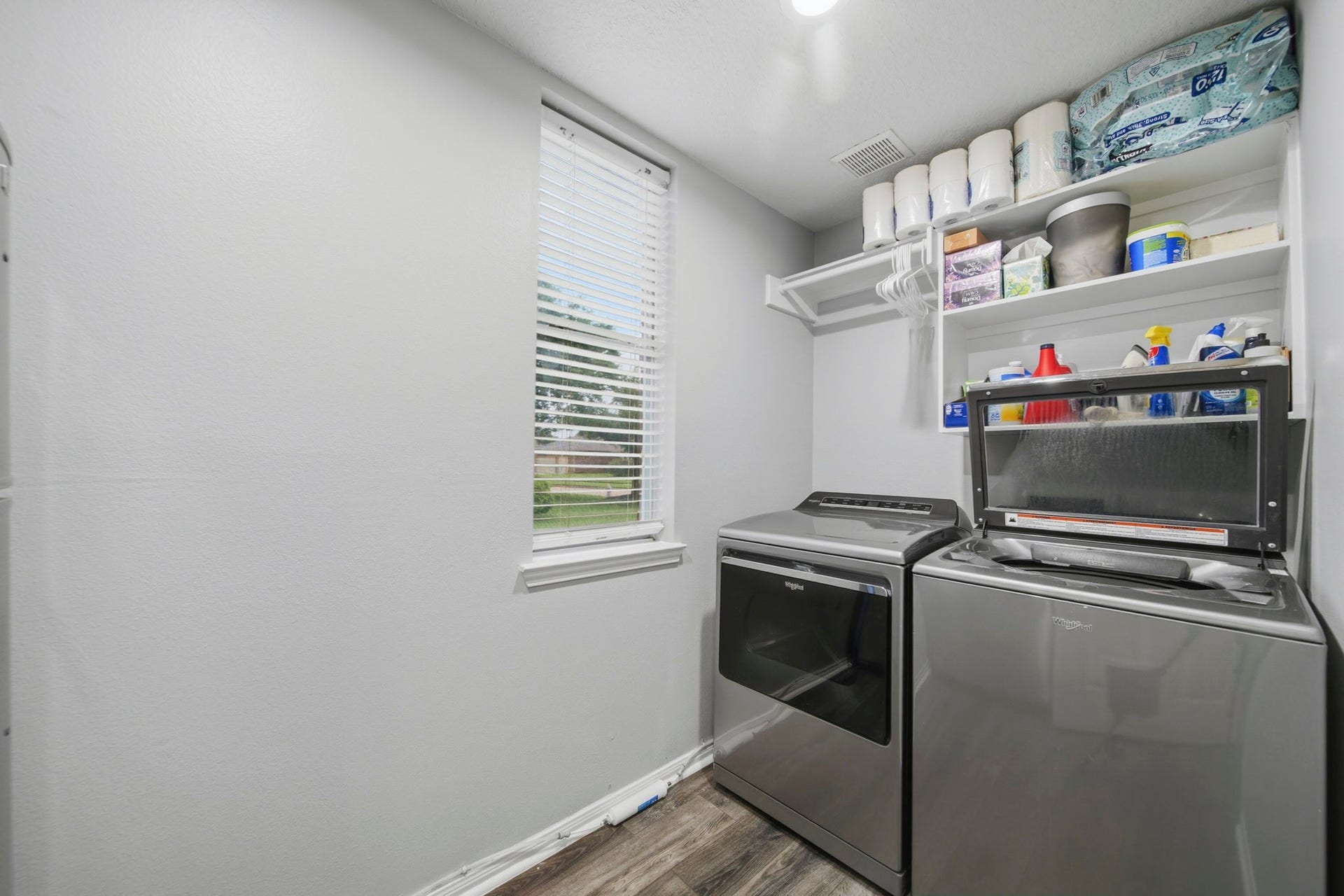 Laundry room featuring ample shelving for storage.