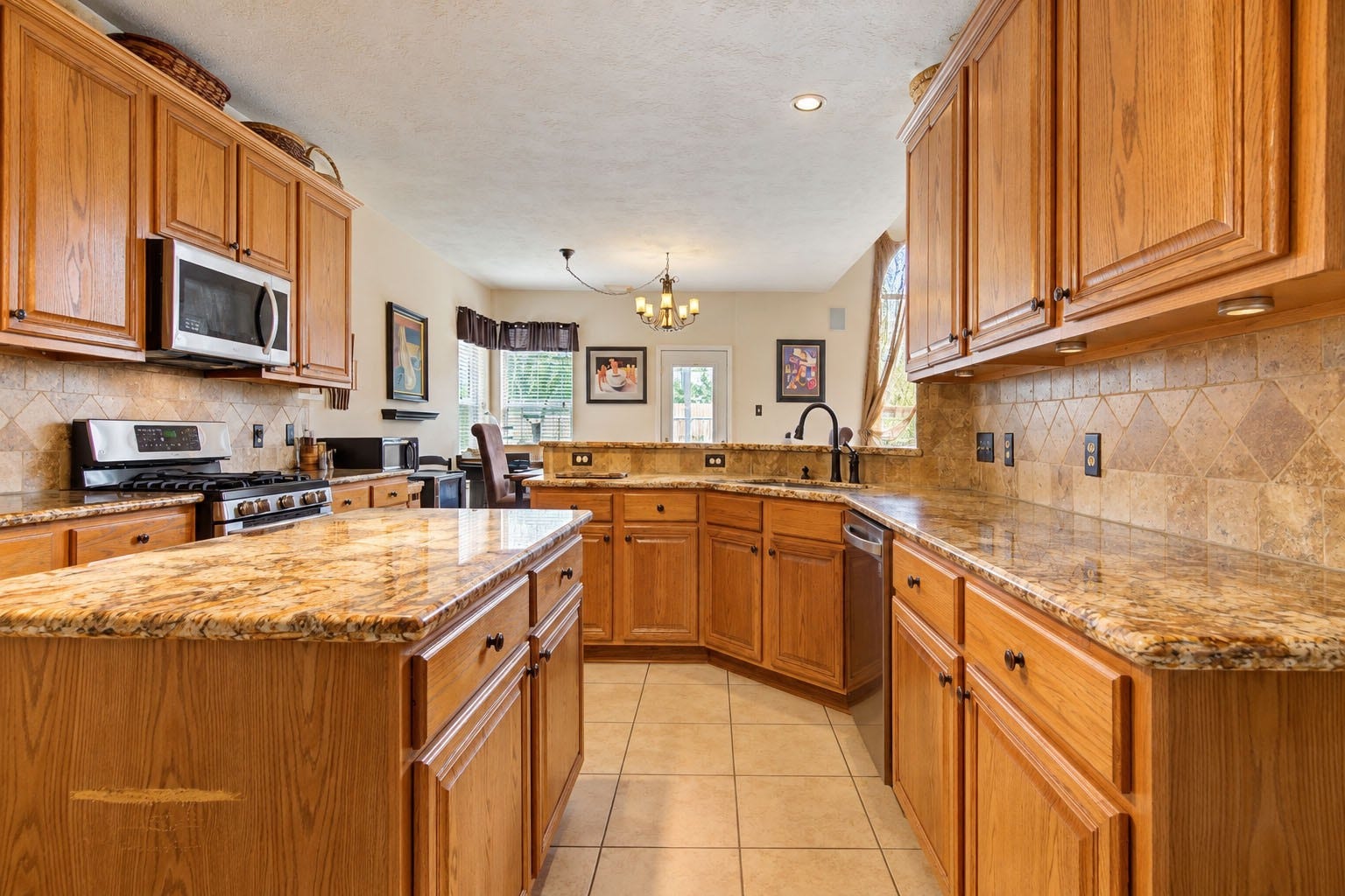 8111 Summer Wind Court, Sugar Land, TX 77479 Kitchen with Island and granite countertops and stainless steel appliances.