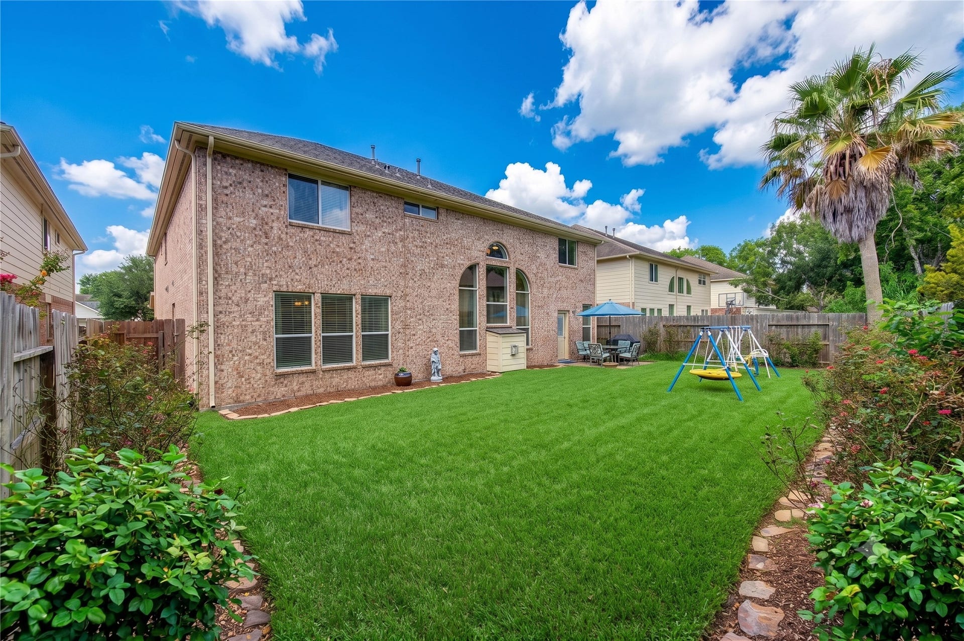 8111 Summer Wind Court, Sugar Land, TX 77479 Expansive backyard with green lawn, perfect for family gatherings.