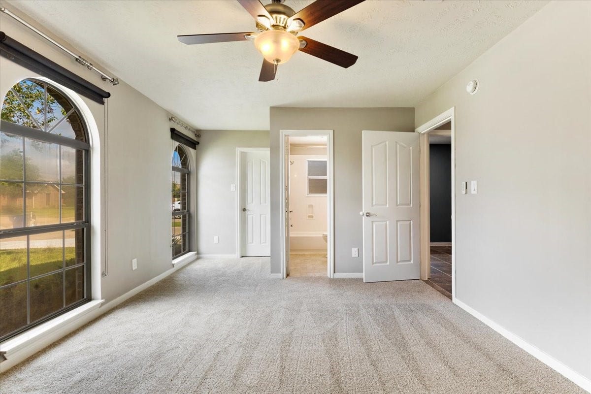 Welcome guests with a comfortable bedroom featuring new carpet and convenient bathroom access. Generous natural light makes the space inviting for a short visit or everyday use.