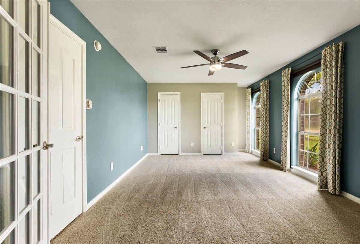 New carpet gives this spacious front bedroom a fresh, comfortable finish. French doors add flexibility for a home office or guest room, giving you options as the way you use your home evolves.