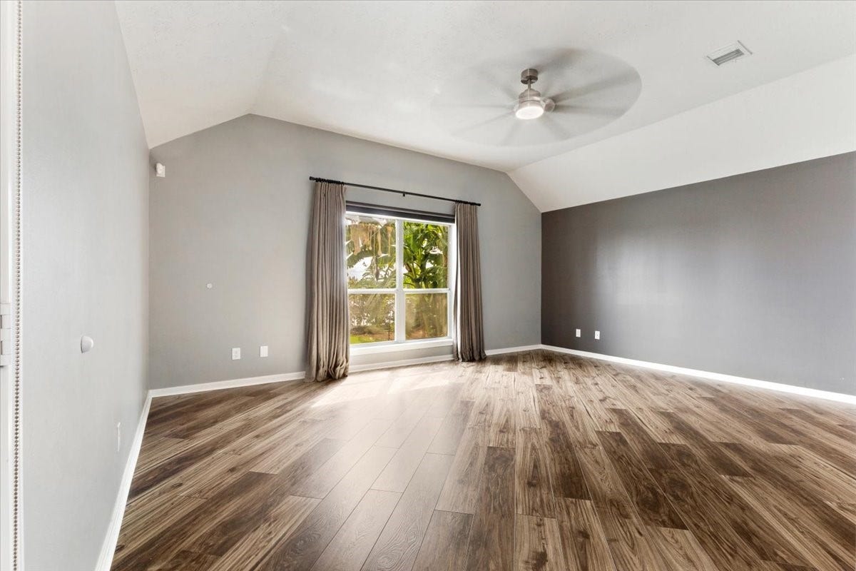 Make room for a slower start and a comfortable end to the day. The spacious primary bedroom combines wood floors, natural light and backyard greenery to create an inviting place to unwind.