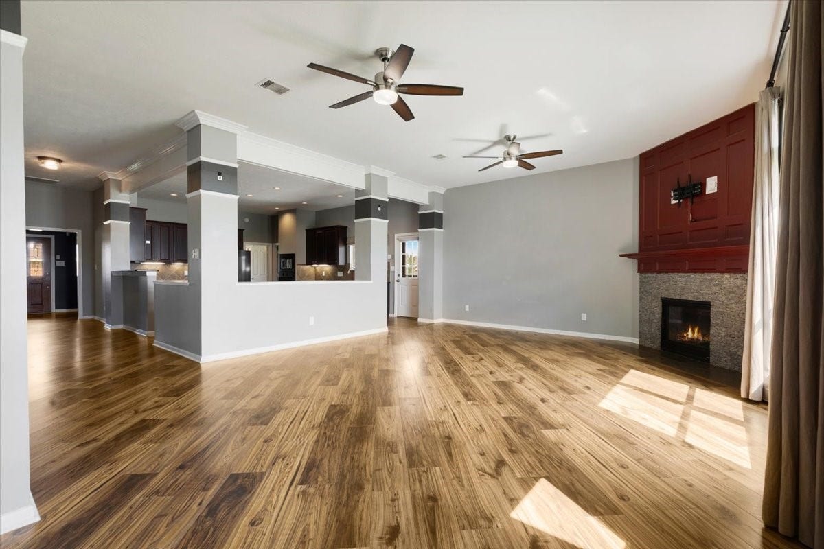 Gather around the fireplace, enjoy the warmth of wood floors and stay connected to the kitchen. This spacious living area gives everyday relaxing and weekend entertaining a comfortable place to come together.