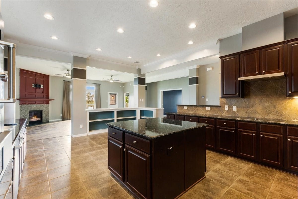 Keep the conversation going while dinner comes together. The kitchen island and open connection to the living room let the cook remain part of the gathering, with useful storage close at hand.