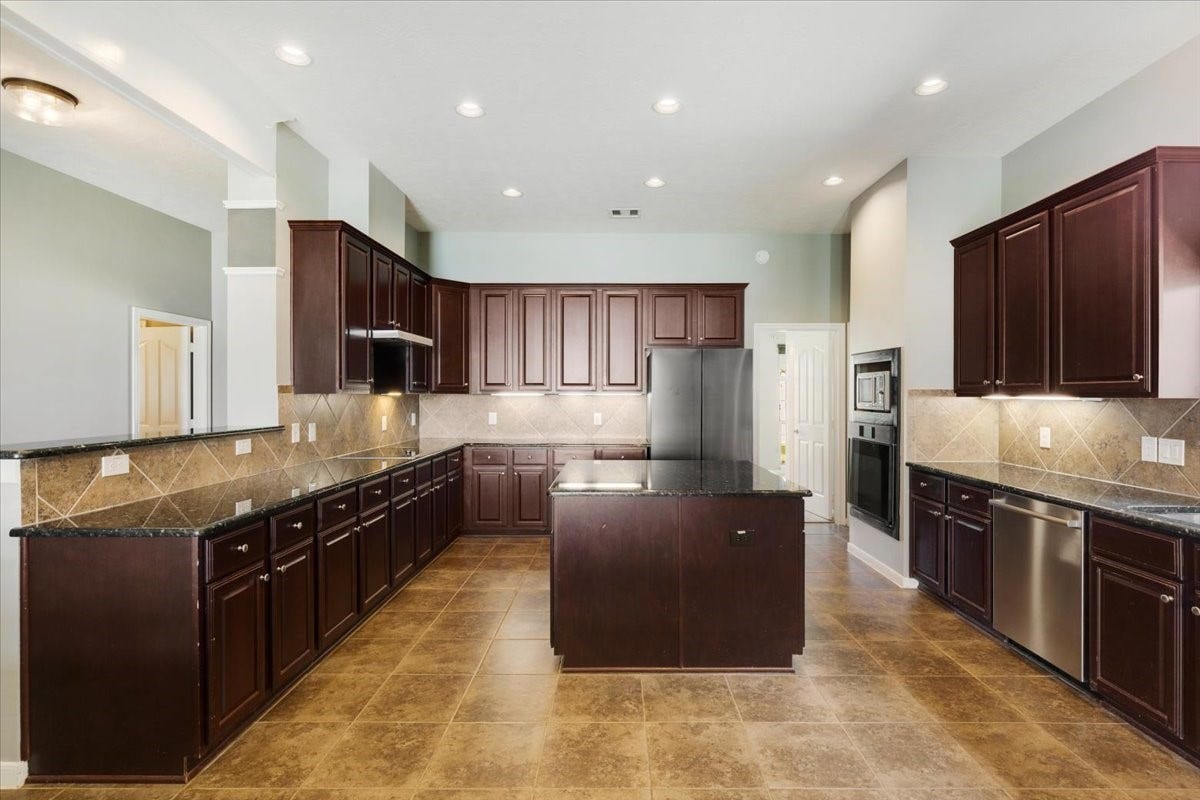 A kitchen with room to cook, organize and create. Generous counter space, abundant cabinetry and a center island make preparing everyday meals or hosting a larger gathering feel more manageable.