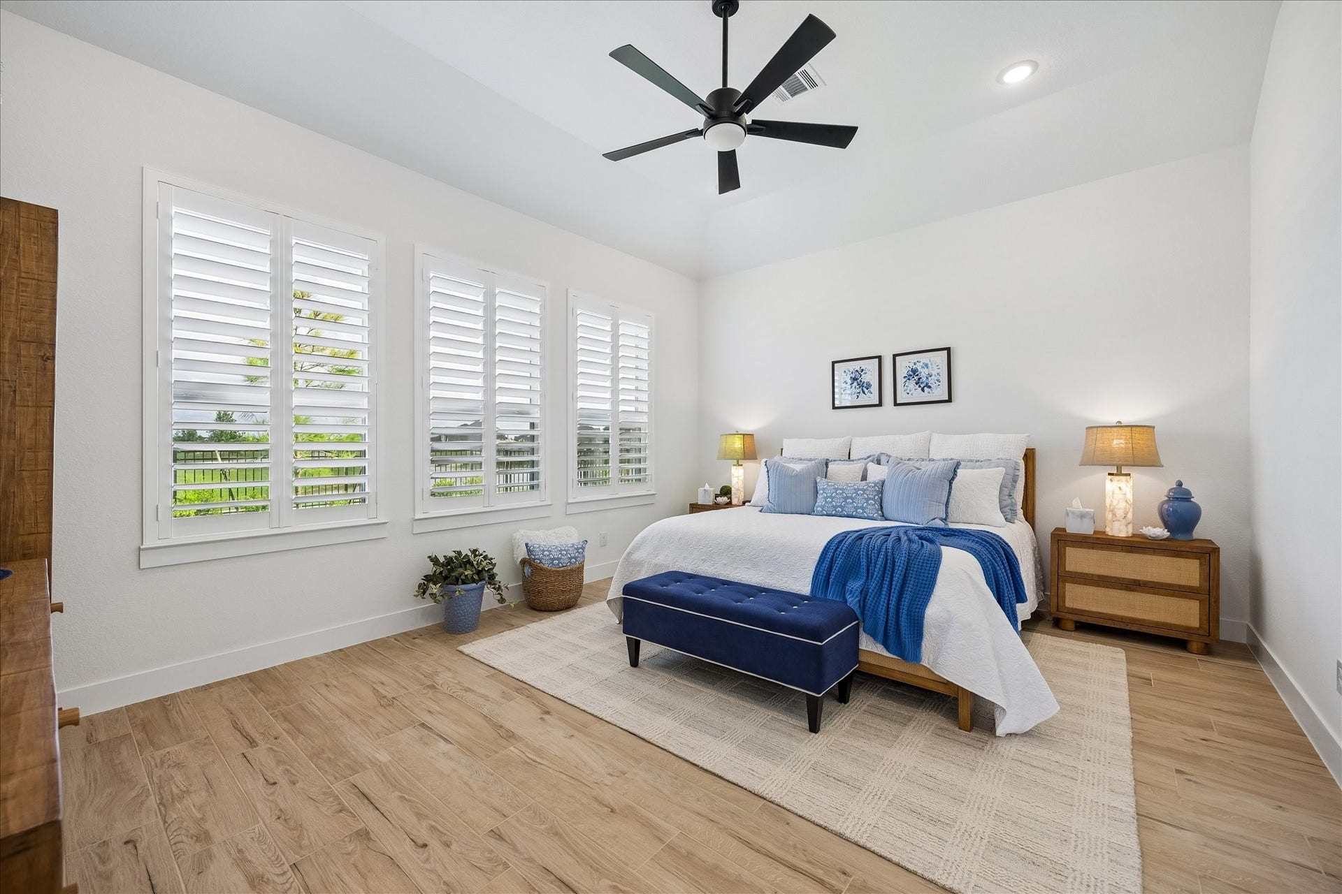 32438 Violet Dancer Court, Fulshear, TX 77441 Spacious primary retreat featuring beautiful scenic views, custom plantation shutters, and upgraded wood-plank tile flooring. This light-filled room offers an expansive layout perfect for accommodating oversized furniture.