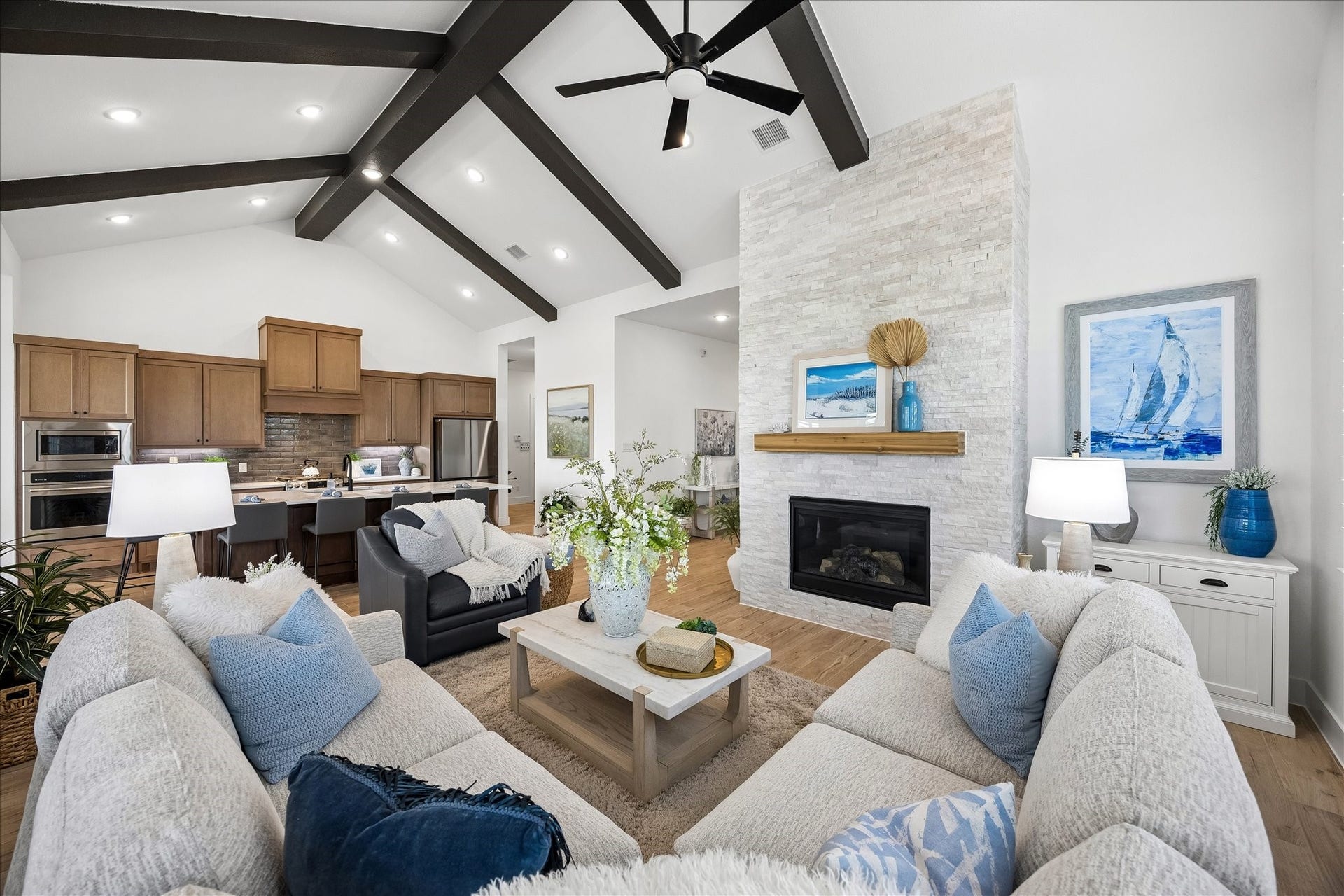 The home features an open-concept layout where views extend seamlessly from the front entry through the kitchen, creating an inviting flow and effortless connection throughout the living space.
