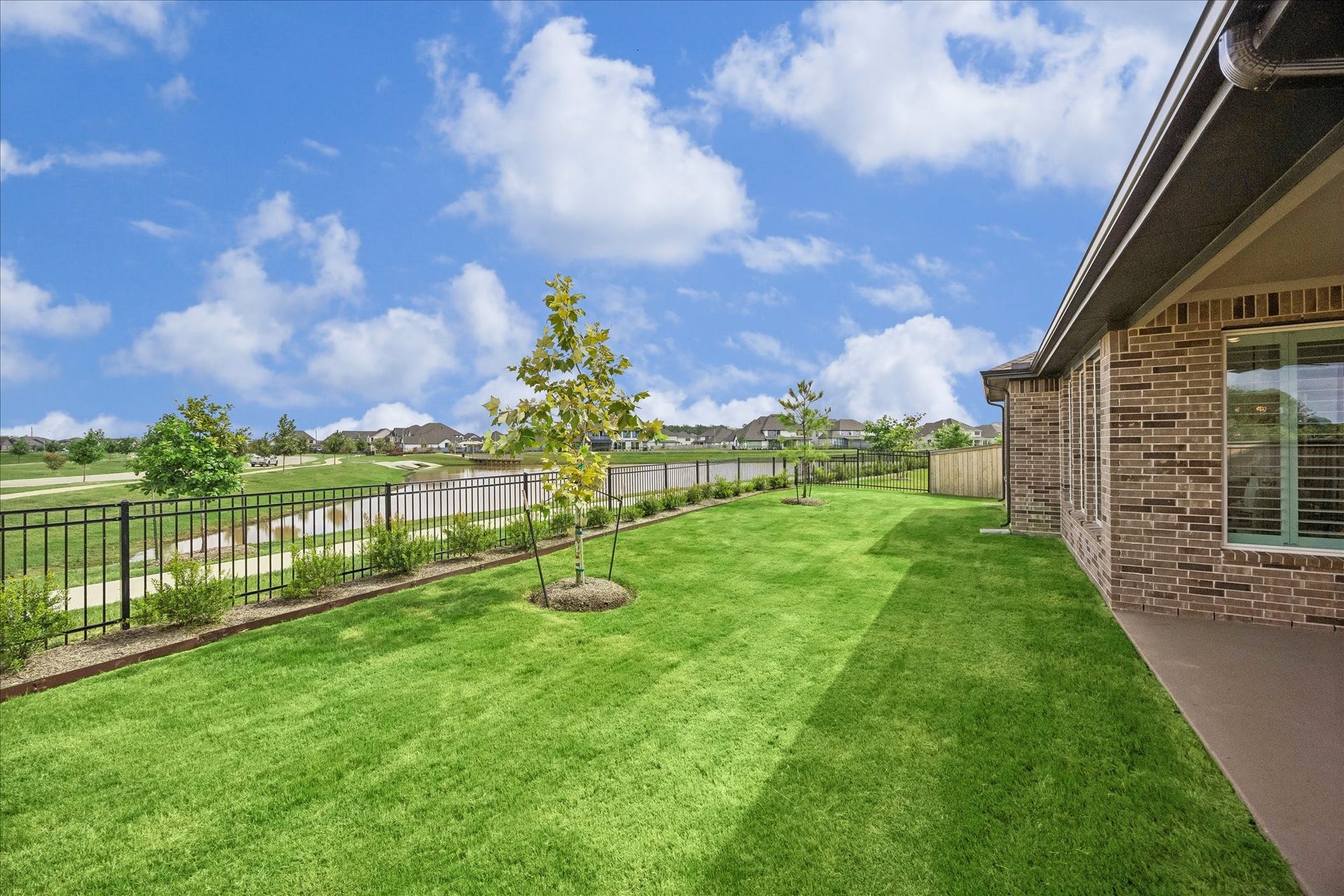 32438 Violet Dancer Court, Fulshear, TX 77441 Beautiful backyard views of the water and trails. Backyard features professional landscaping, sprinkler system, full home gutters and private gate access to walking path.
