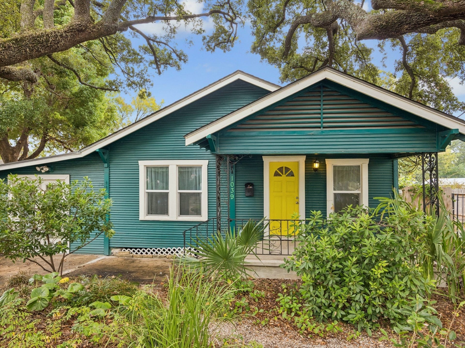 1039 Dunbar Street, Houston, TX 77009 Nestled beneath a canopy of beautiful, mature trees, this character-filled home makes a memorable first impression with its colorful exterior and welcoming covered entry.