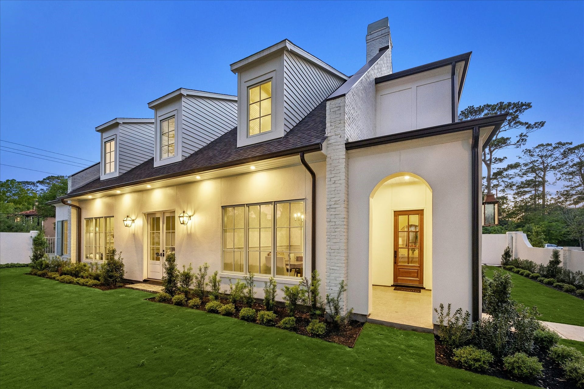 10801 Long Shadow Lane, Hunters Creek Village, TX 77024 Welcoming front entry with arched covered porch, gas lanterns & elegant wood stained door. Large windows & French doors bring in natural light while manicured landscaping & exterior lighting enhance the fabulous curb appeal!