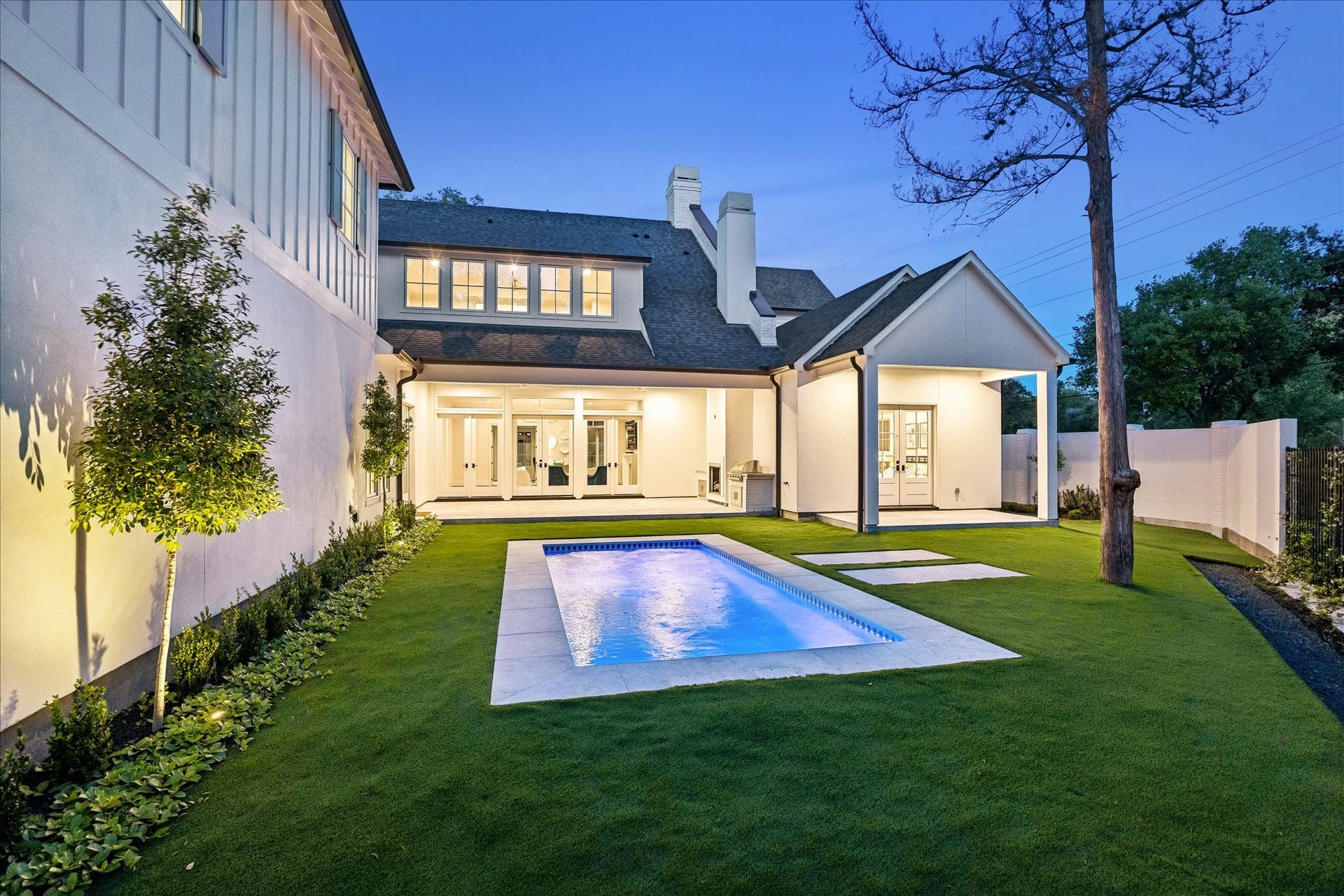 10801 Long Shadow Lane, Hunters Creek Village, TX 77024 Another view highlights the covered outdoor living areas overlooking the heated pool & turf yard. Fenced grounds & landscape lighting create a beautifully designed outdoor setting.