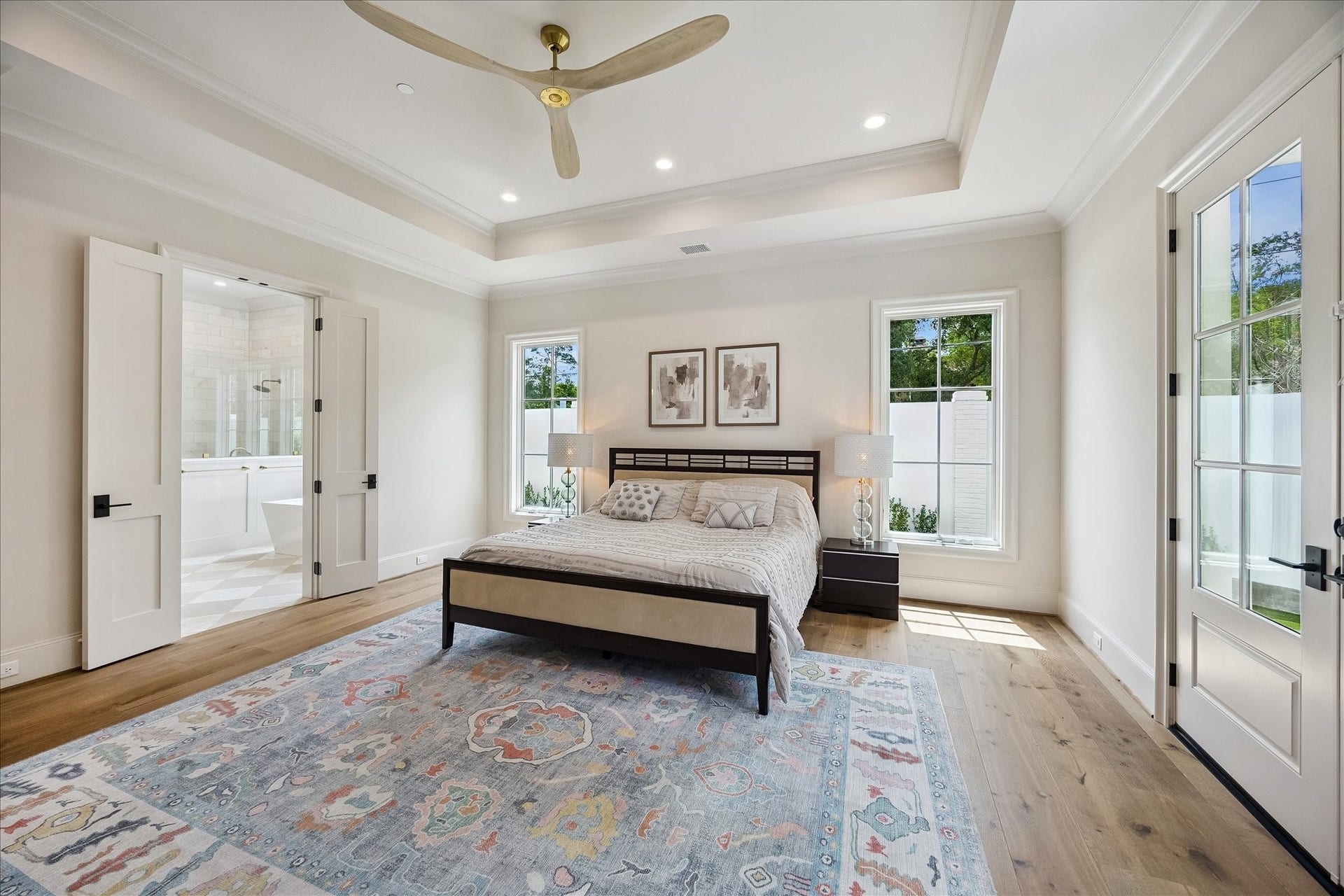 10801 Long Shadow Lane, Hunters Creek Village, TX 77024 From this perspective, the primary suites thoughtful layout continues with symmetrical windows framing the headboard and enhancing the light-filled ambiance. A seamless transition leads into the spa-inspired primary bath, while the beautiful finishes and airy scale complete this luxurious, private retreat.