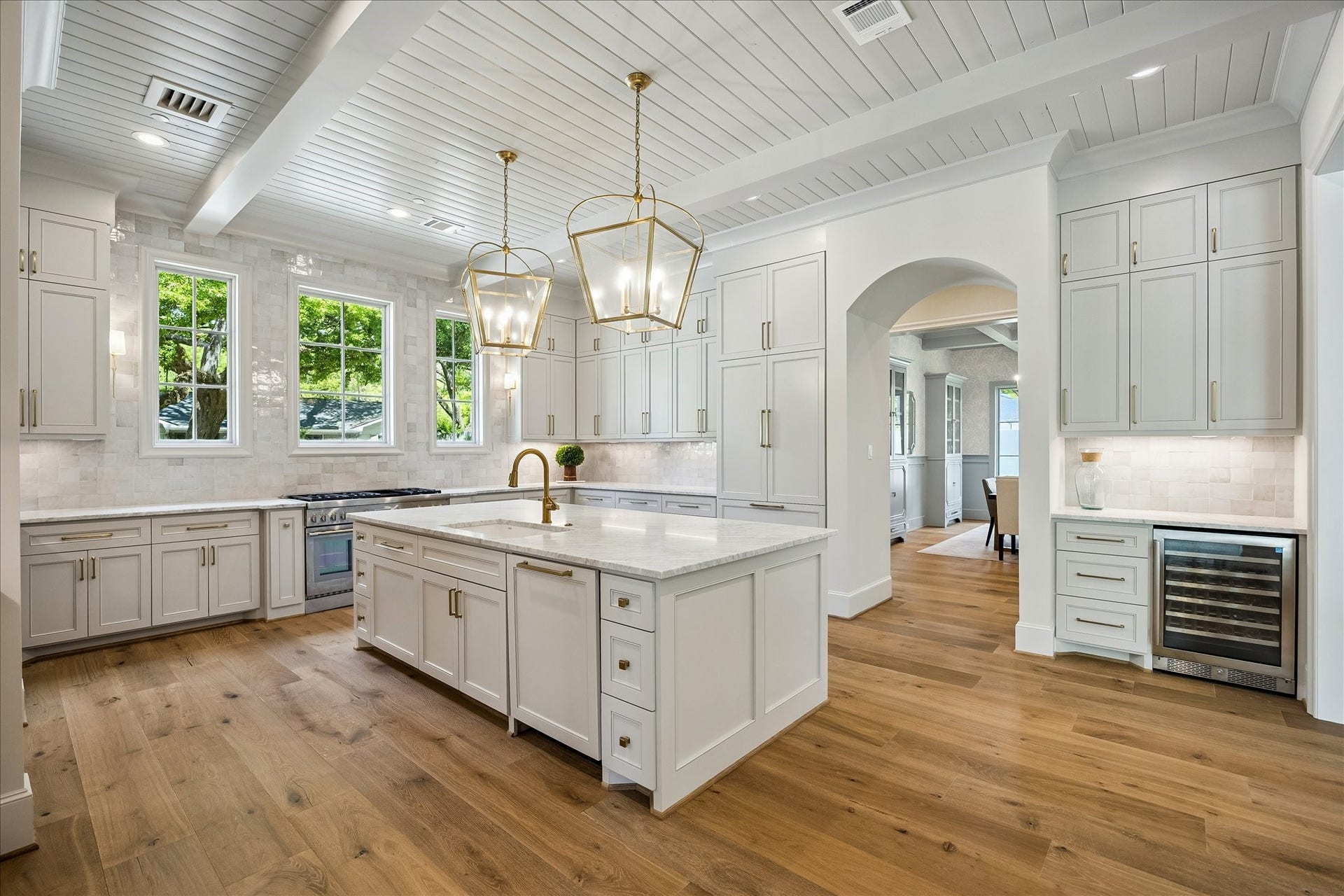 10801 Long Shadow Lane, Hunters Creek Village, TX 77024 Kitchen perspective highlighting the stunning beamed ceiling detail, creating a striking architectural focal point. A dedicated coffee bar w/ built-in Avalon wine cooler adds both function & style to the space.