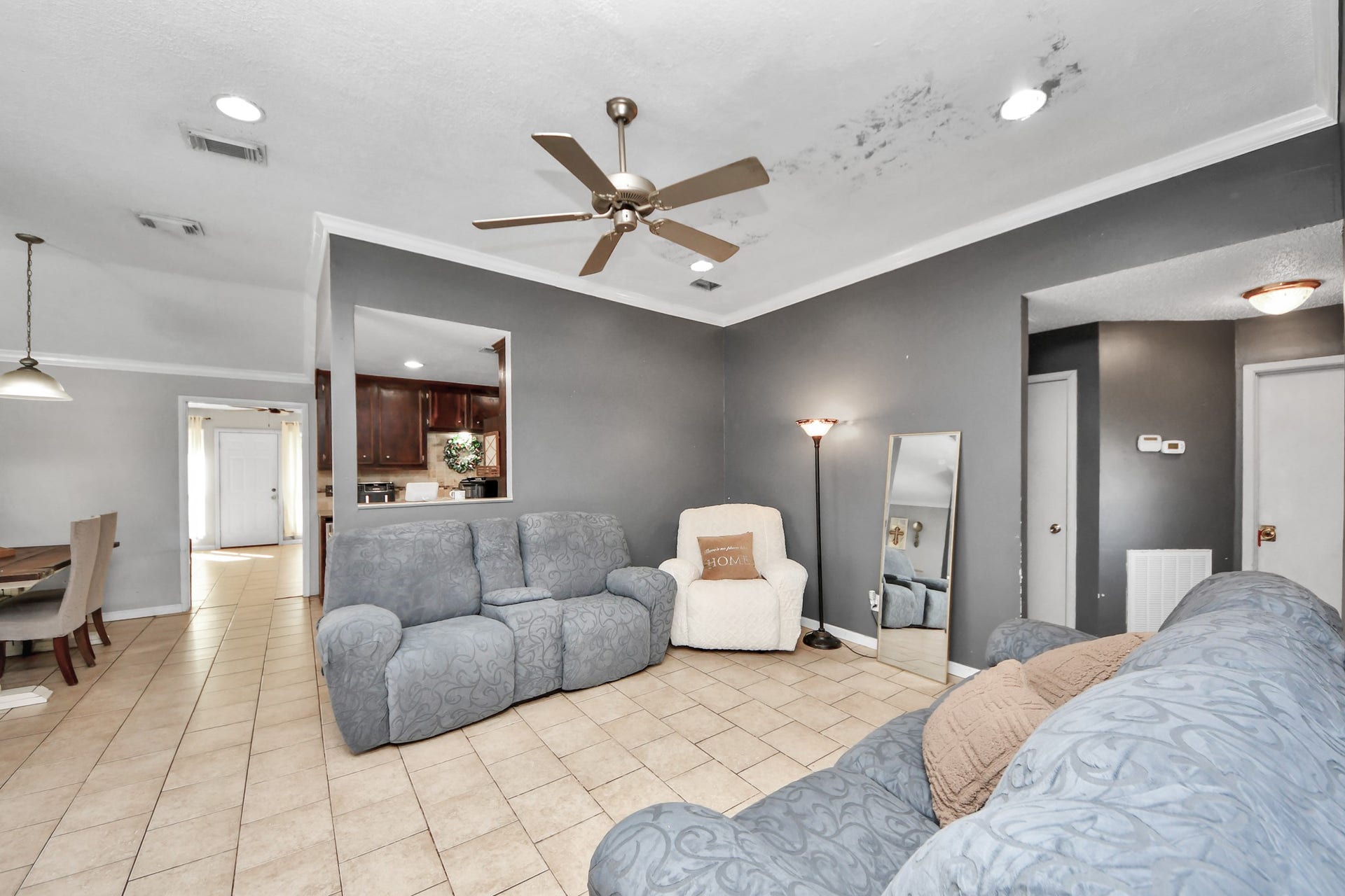 Inviting formal living room featuring tile flooring and a cozy fireplace.