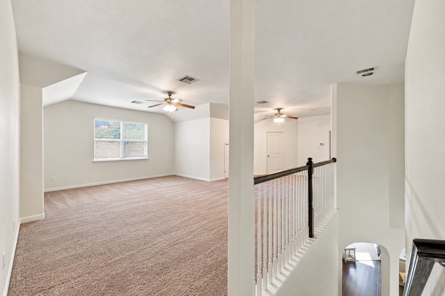 134 Meadow Landing Drive, Conroe, TX 77384 This photo has been digitally (un)staged (all furniture and decor removed) to show the potential of this expansive Game Room upstairs. | Curious how your furniture would look? Download this picture and take pictures of your current furniture and upload both into ChatGPT and ask it to stage the room using your furniture--it won't look exact but it can give you a great idea!