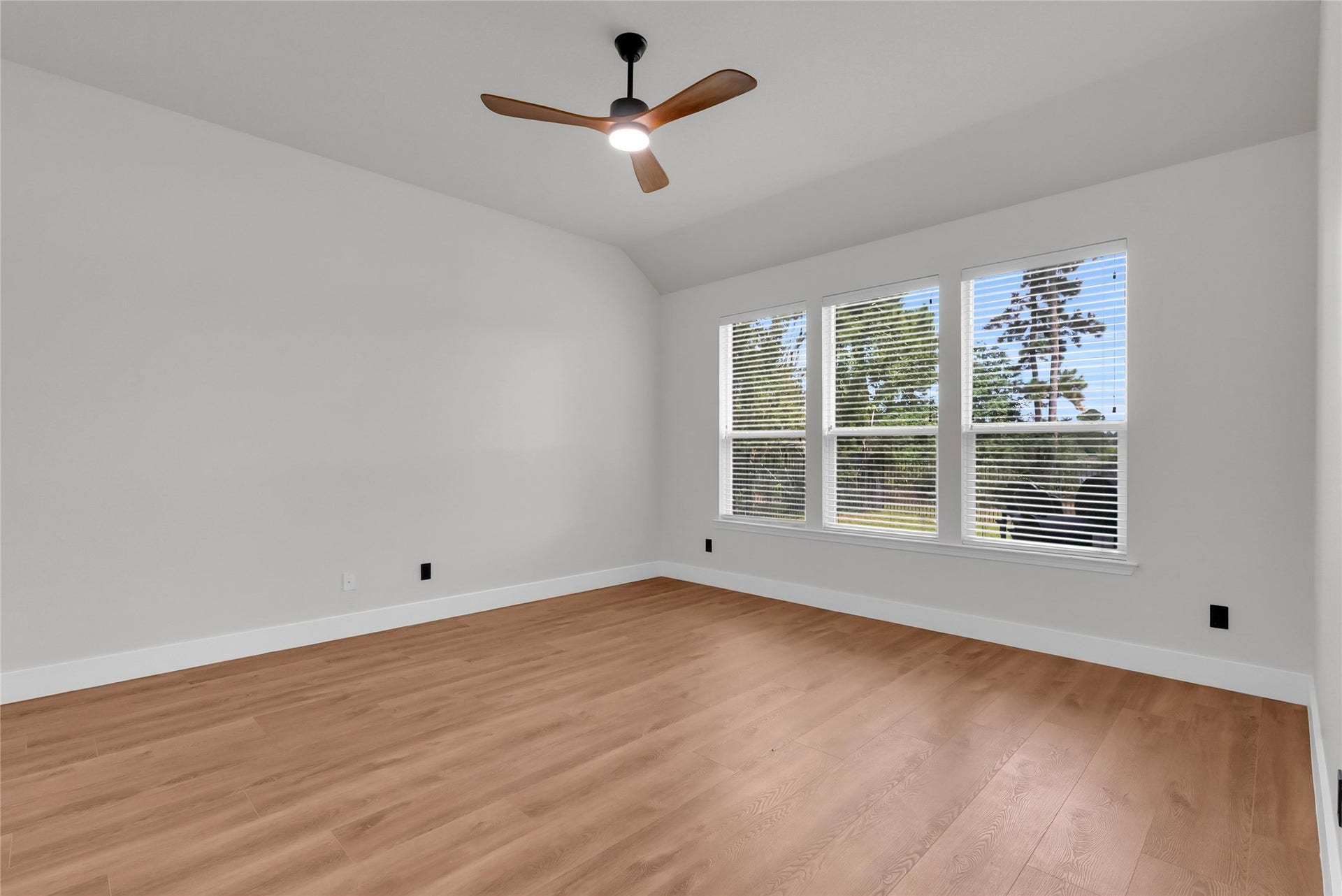78 Heritage Mill, The Woodlands, TX 77375 Spacious third bedroom upstairs featuring gorgeous new wood flooring, fresh neutral paint, and a bright, versatile layout with plenty of room for family or guests.
