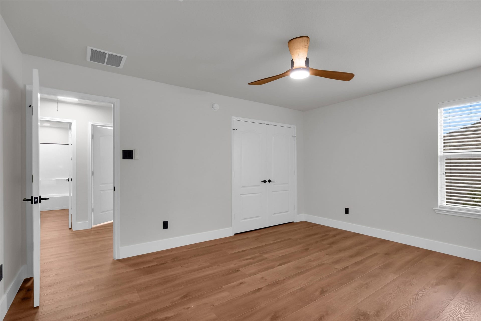 78 Heritage Mill, The Woodlands, TX 77375 Spacious fourth bedroom upstairs featuring gorgeous new wood flooring, fresh neutral paint, and a bright, versatile layout with plenty of room for family or guests.