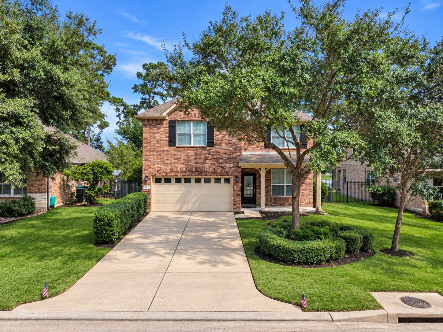 78 Heritage Mill, The Woodlands, TX 77375 This charming two-story home features a timeless brick exterior, mature shade trees, and beautifully maintained landscaping. An expansive driveway leads to the two-car garage, while the welcoming covered front porch adds to the home's inviting appeal.