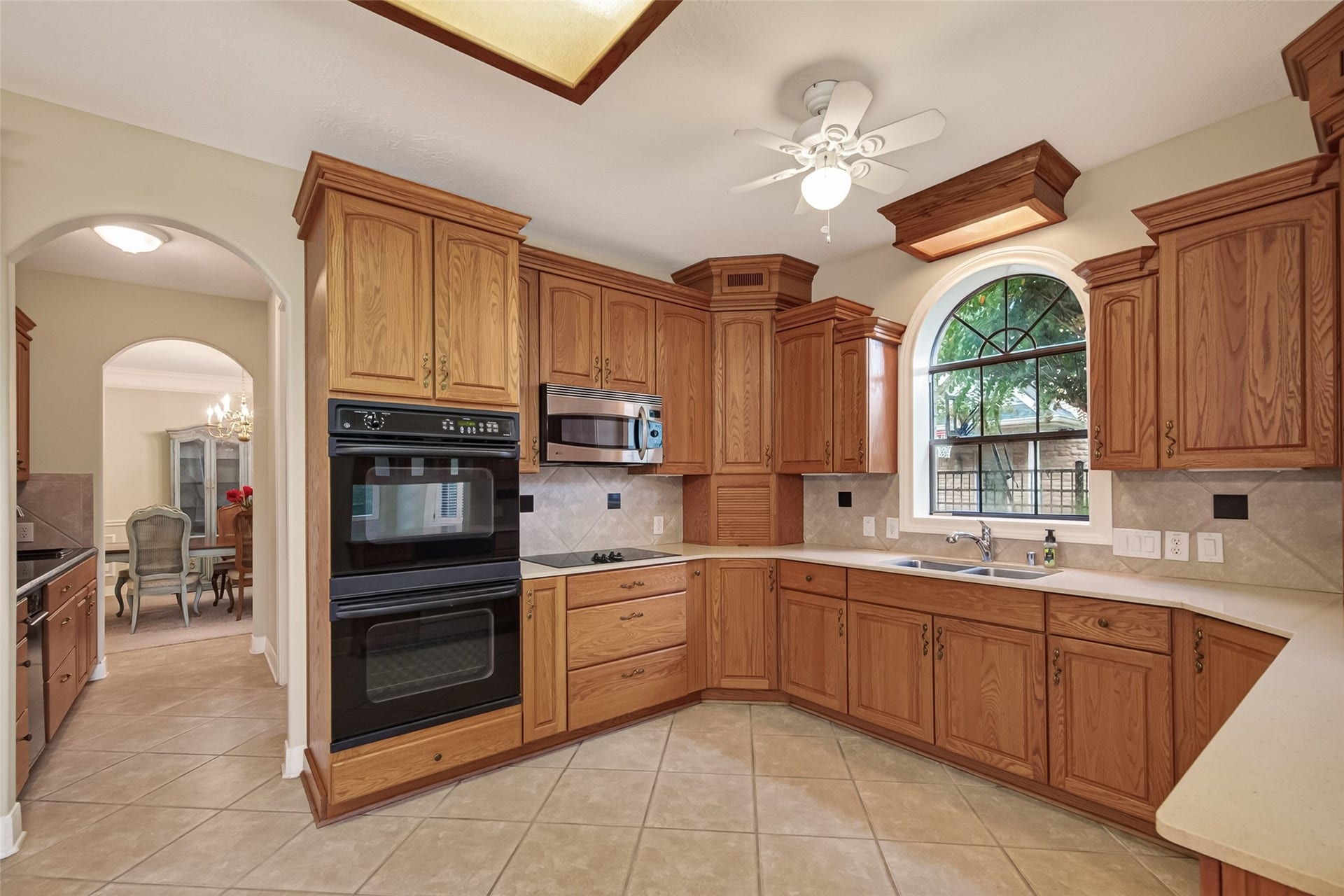 This view shows the Butler's Pantry to the right and leads to the Formal Dining Room. Custom cabinets and double ovens in the Kitchen.