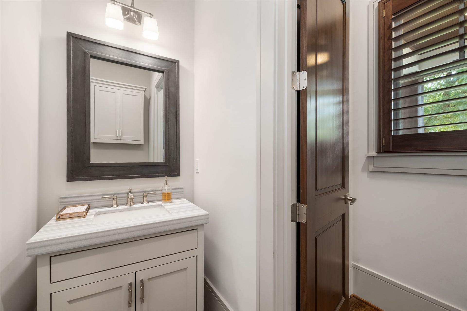 The powder bath is across the foyer from the home office