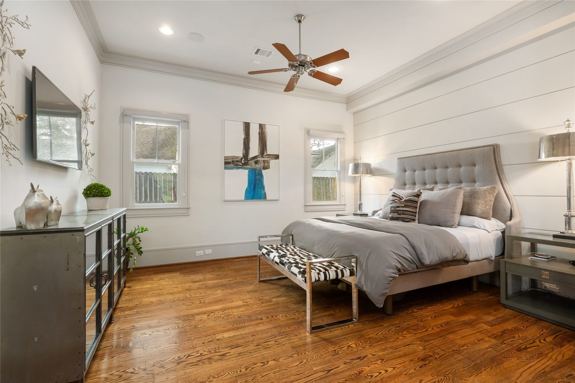 The large primary suite has doors that open to the covered back patio