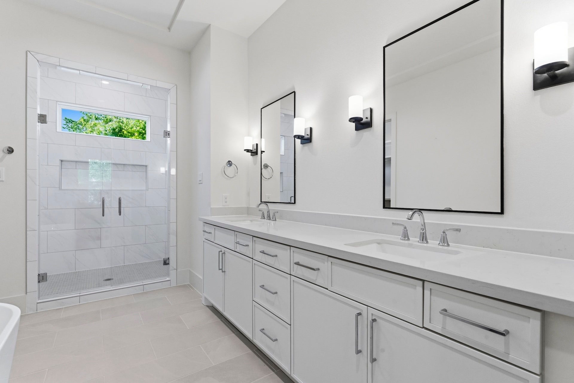 Spa Inspired Retreat  This primary bath features double vanities, quartz count tops, framed
mirrors flanked by wall sconces adorned by a well-appointed bathroom chandelier. Bring your
night to a perfect close in the stand-alone soaking tub.