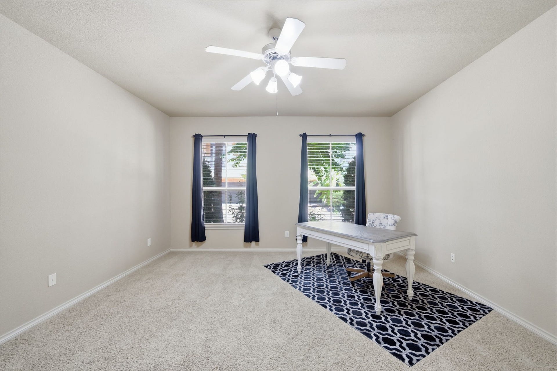 15 Laurelwood Drive, Houston, TX 77058 The secondary bedroom has plush carpet and a ceiling fan for comfortable accommodations...