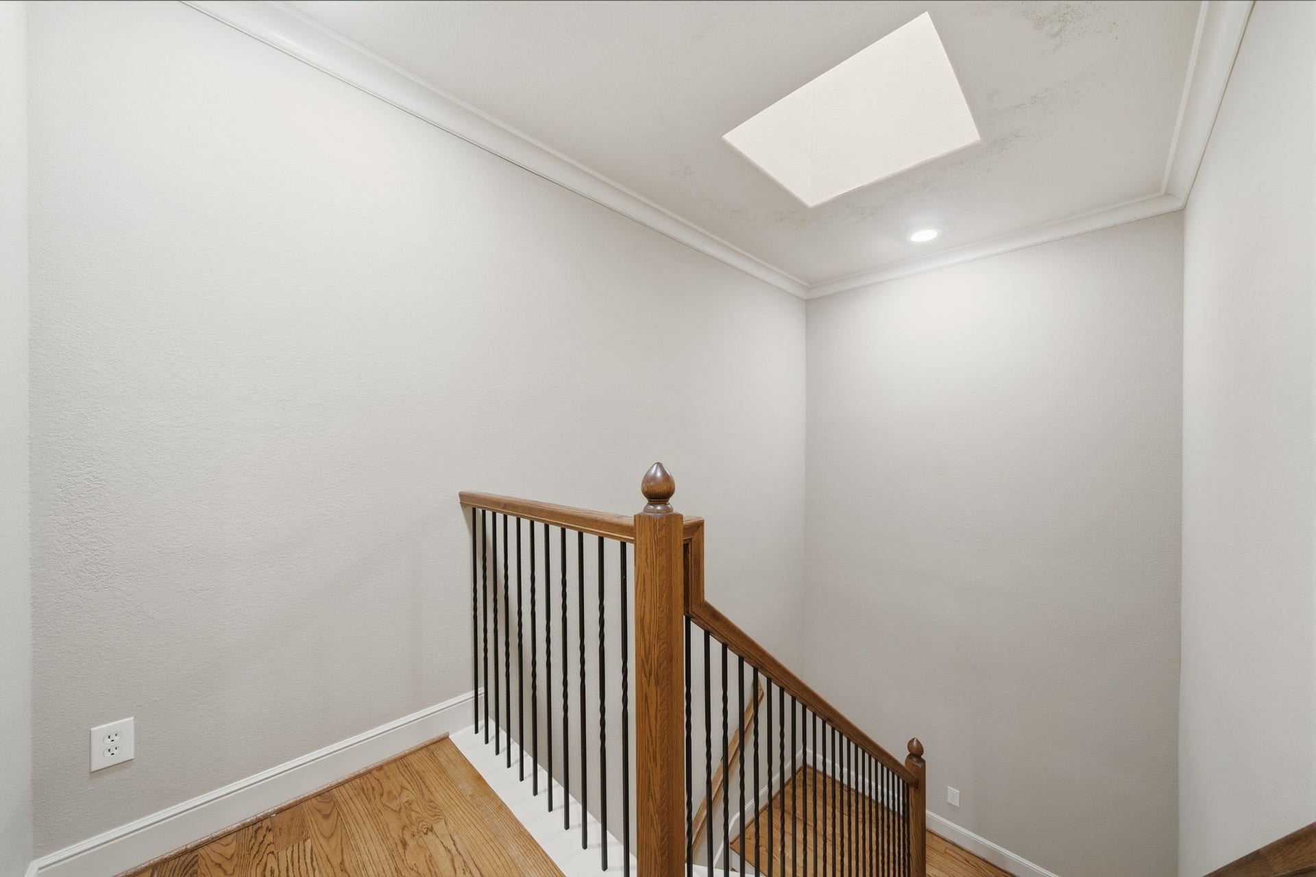 15 Laurelwood Drive, Houston, TX 77058 Wrought iron railings complement the graceful stairway heading to the primary bedroom...
