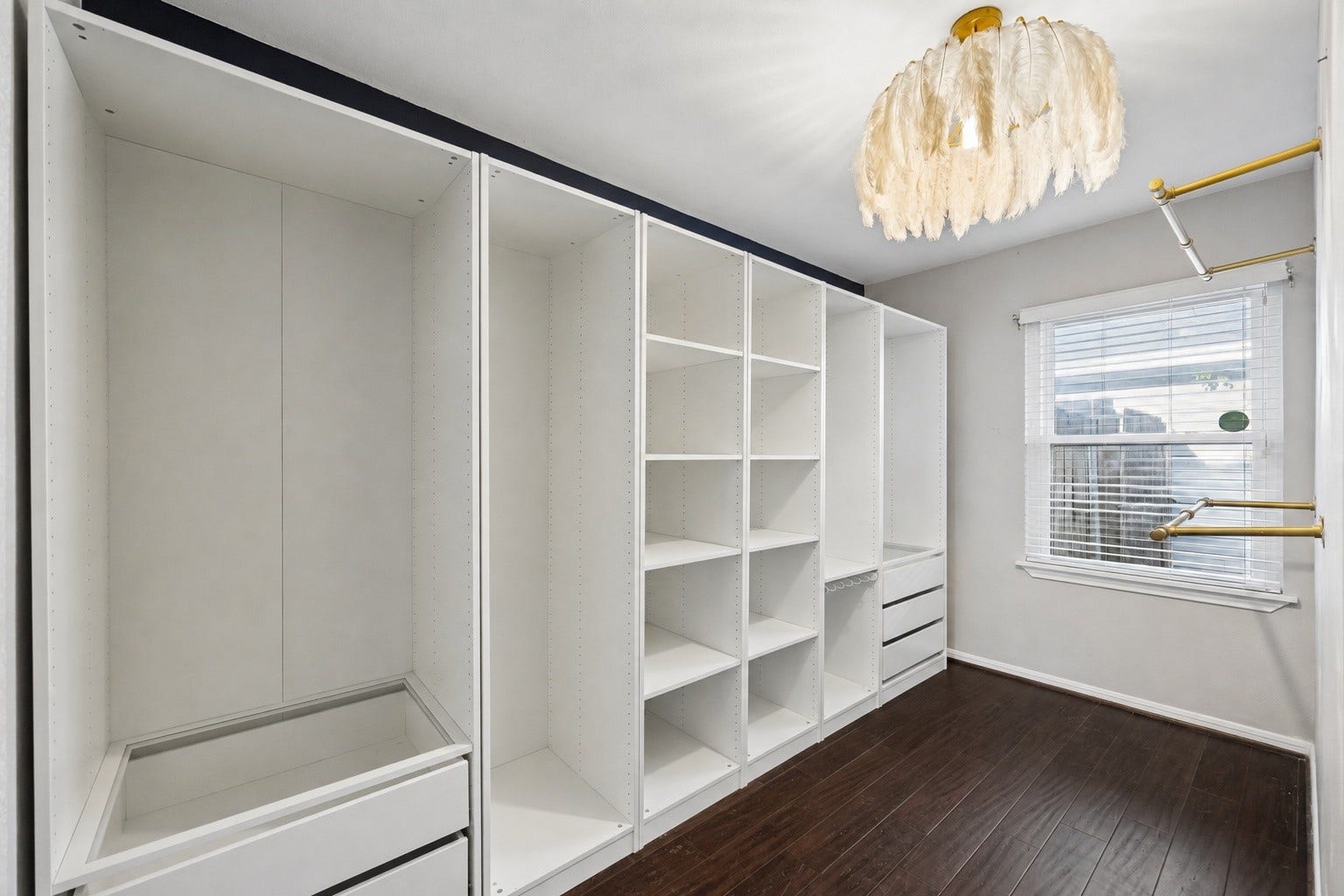 2214 Saxon Drive, Houston, TX 77018 A custom walk in closet offers an impressive combination of hanging space, shelving, drawers, and organization to keep everything neatly within reach. Clean lines and a thoughtfully designed layout make daily routines feel effortless.