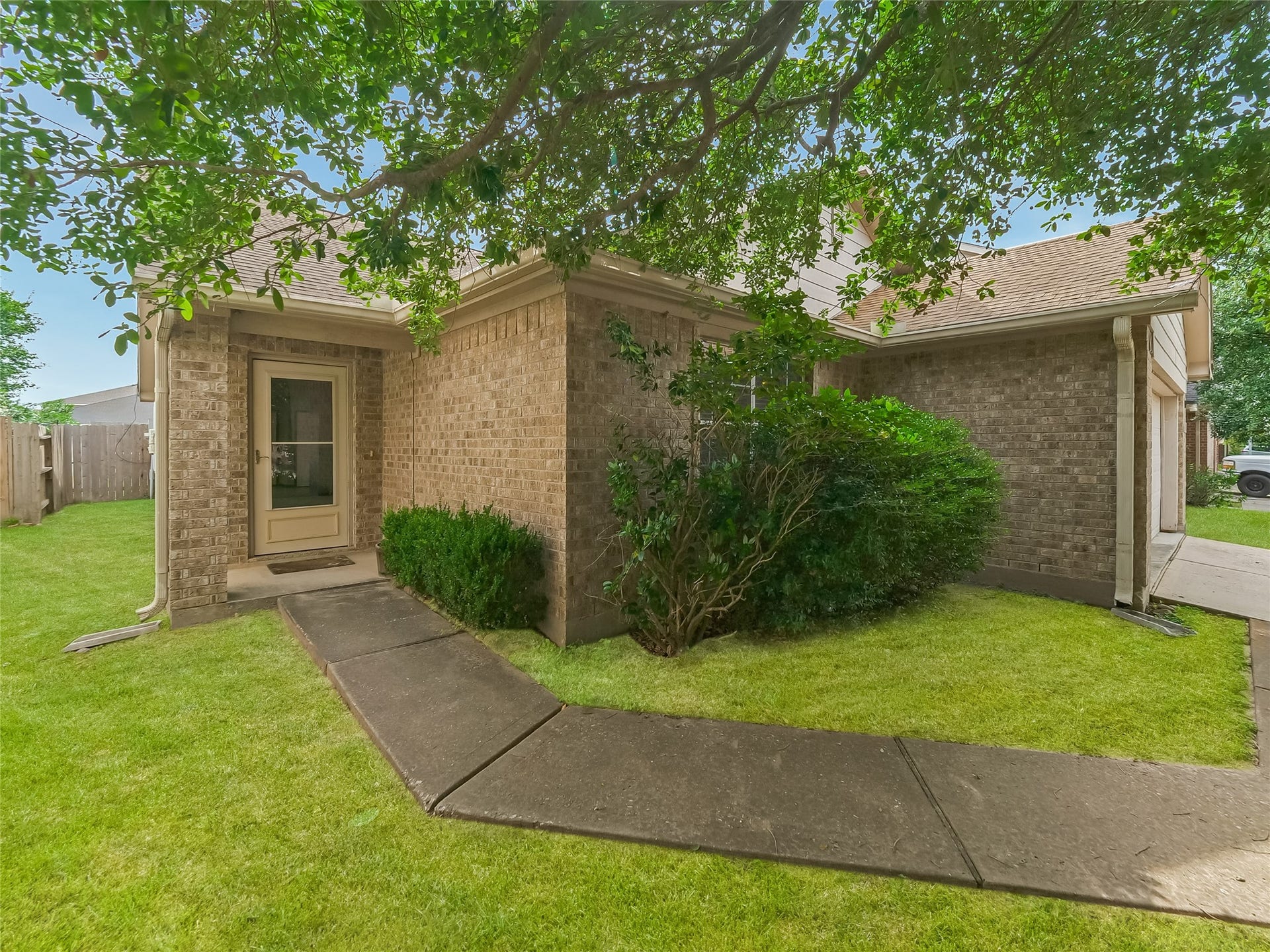 20911 Harvest Terrace Lane, Spring, TX 77379 Side exterior view house featuring front entrance, green lawn, and established landscaping.
