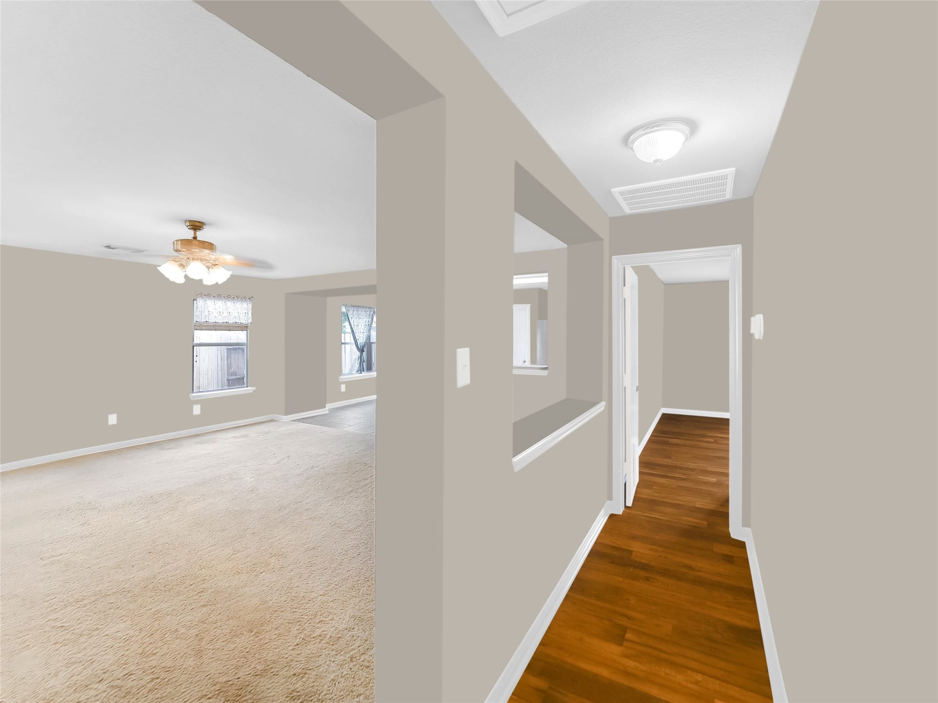 20911 Harvest Terrace Lane, Spring, TX 77379 Interior hallway with open view into adjoining rooms.